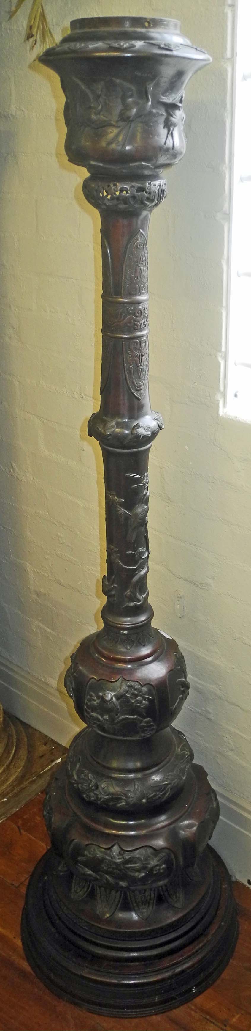 An impressive Japanese Meiji bronze floor standing torchère, the sectional body decorated with