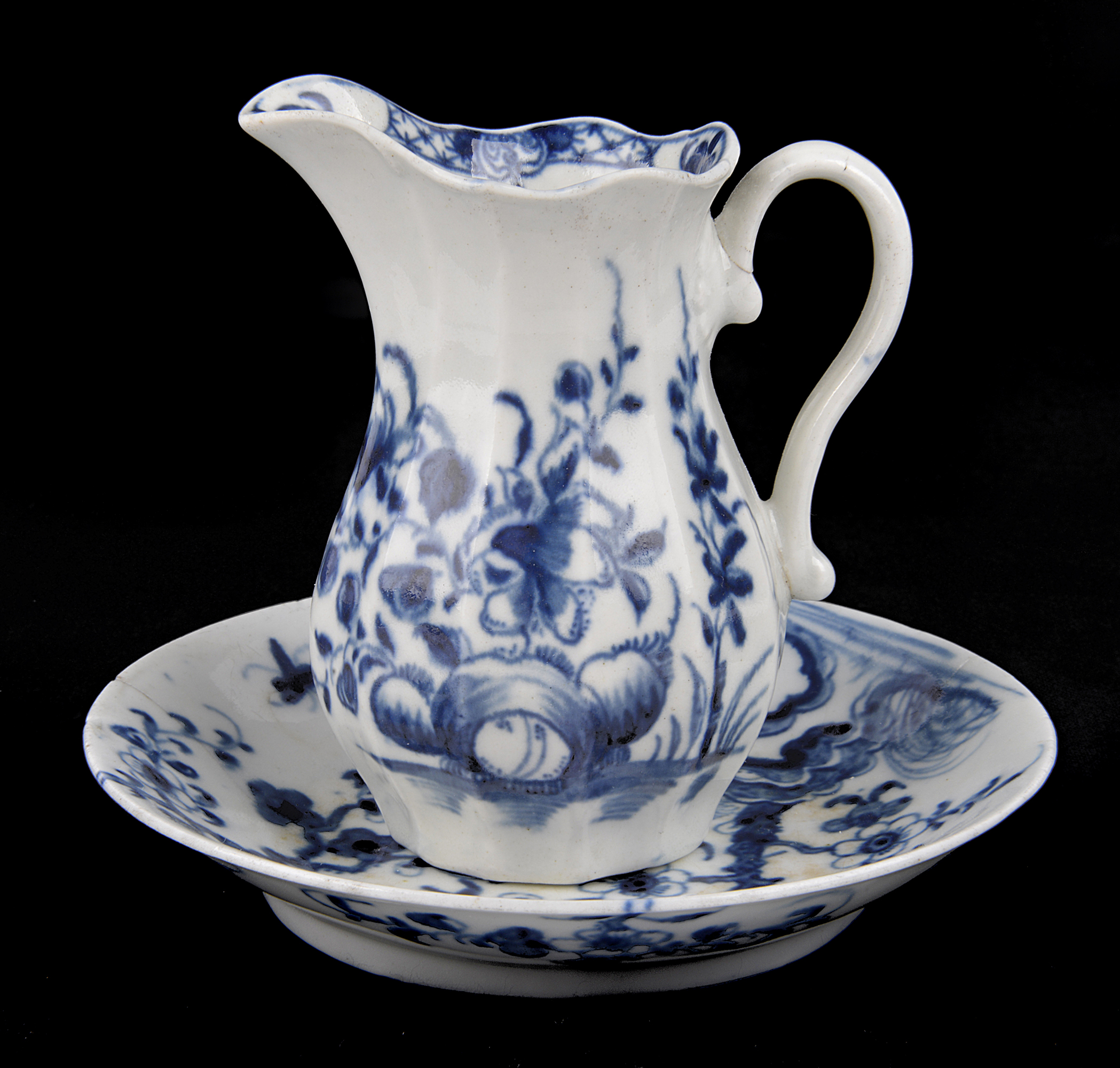 A Worcester prunus pattern blue and white porcelain saucer, circa 1758, and a holly, rock, lily