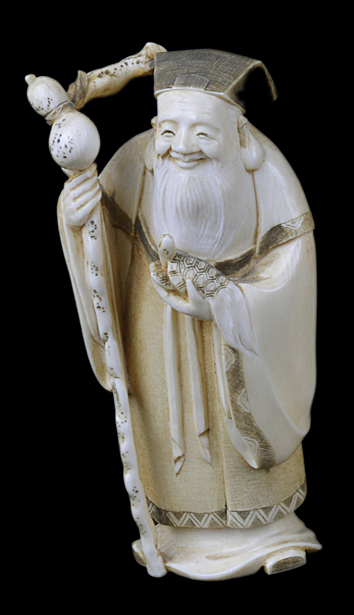 A Japanese antique ivory okimono of an old man holding a turtle.10cm