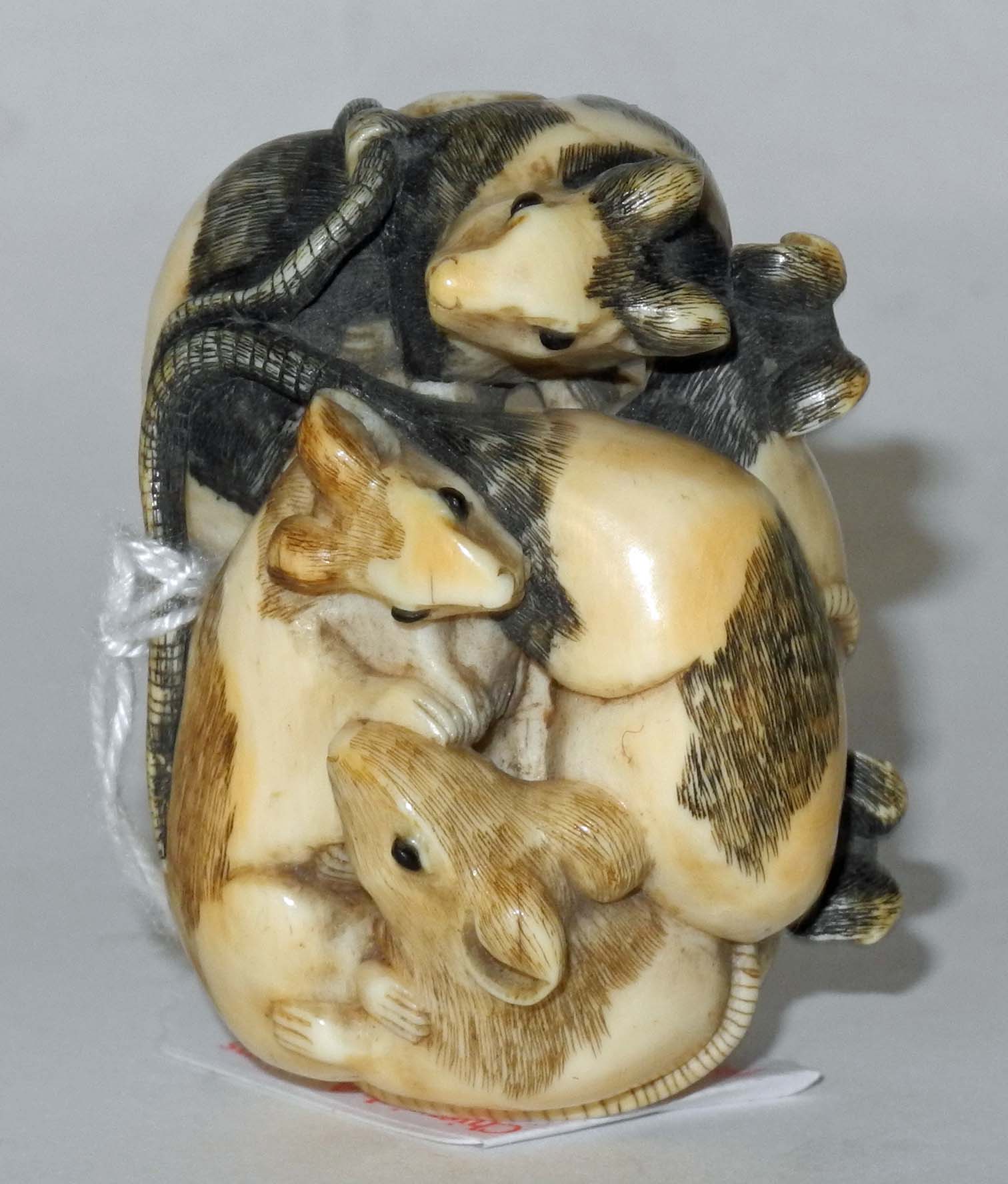 A Japanese ivory netsuke of a group of six rats curled in a ball, signed.5cm wide