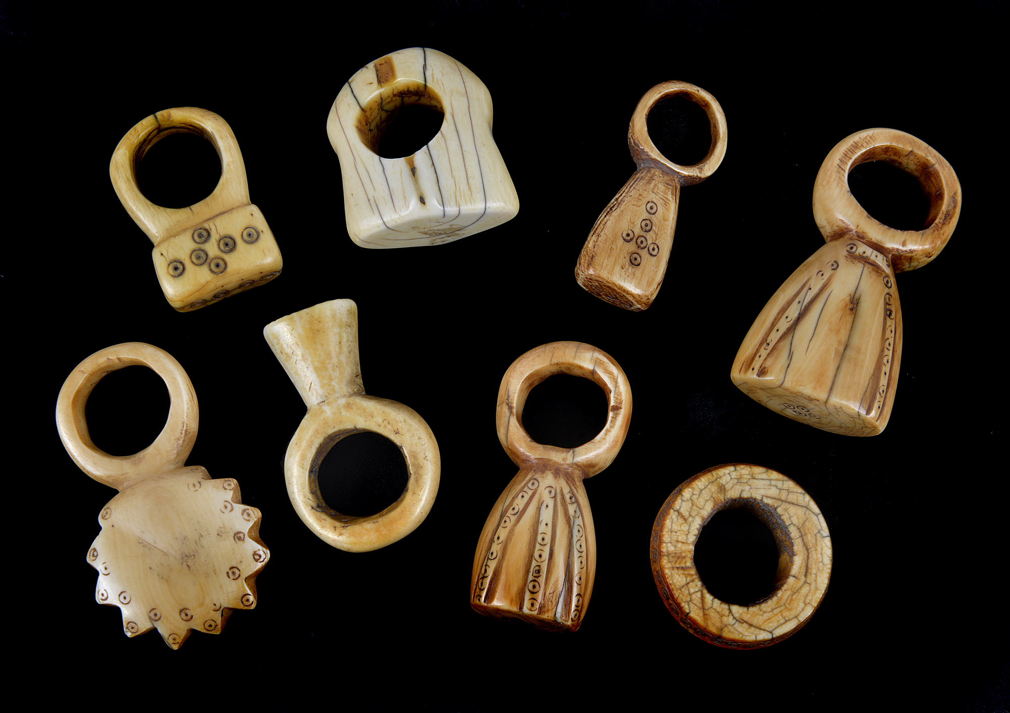 Eight antique African carved ivory ring form items, possibly pendants. (8)