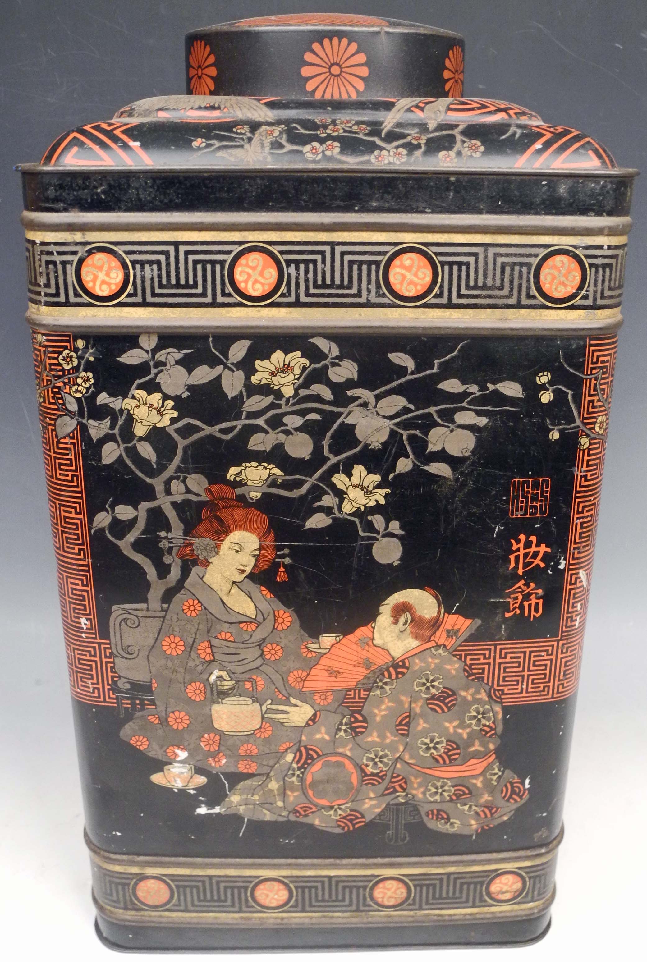 A Japanese oversize shop display tin tea caddy, Geisha, prunus and bird decoration.38cm high