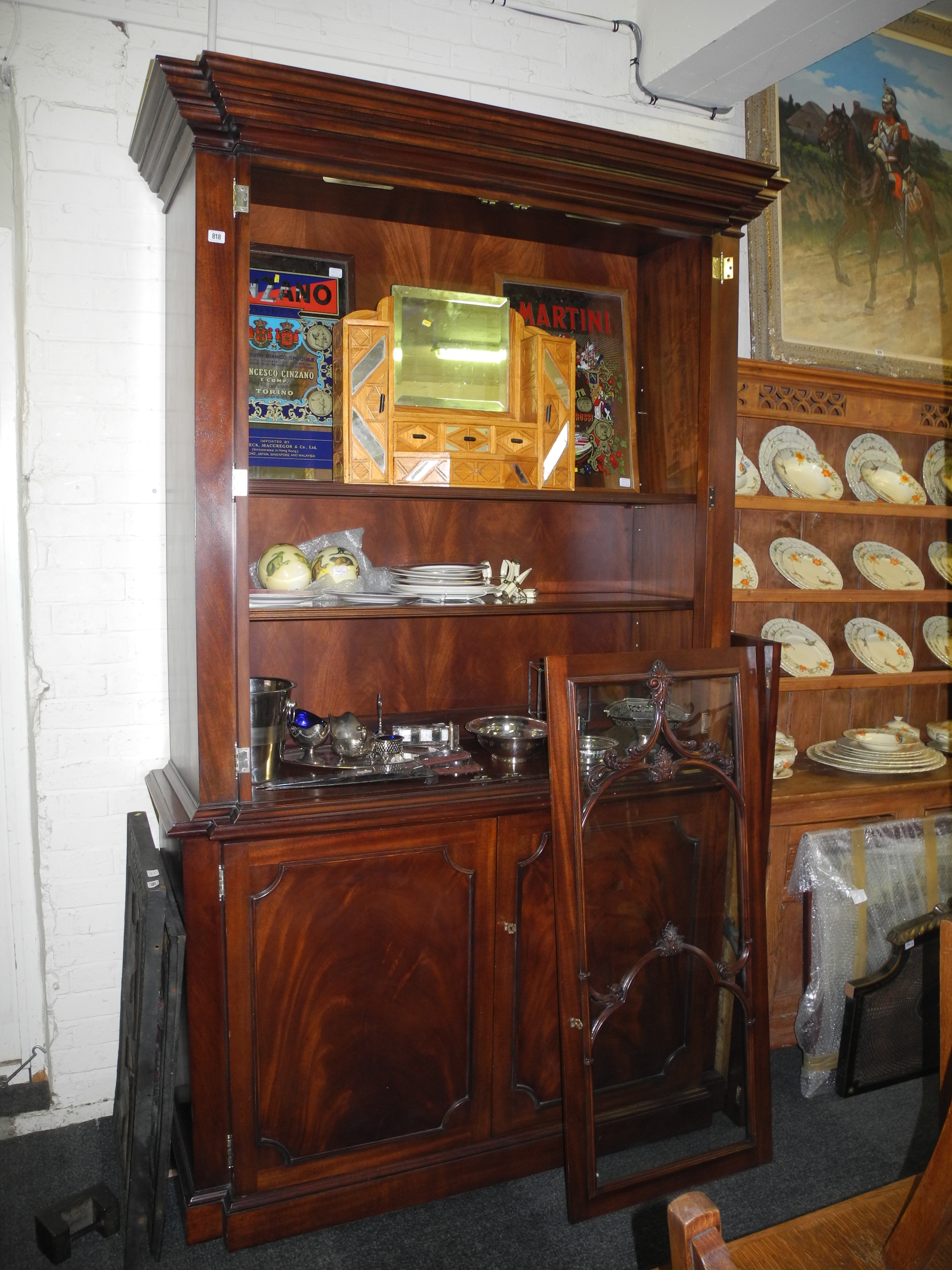 An ex-Ralph Lauren glazed cabinet with scroll and leaf applied decoration double doors and glazed