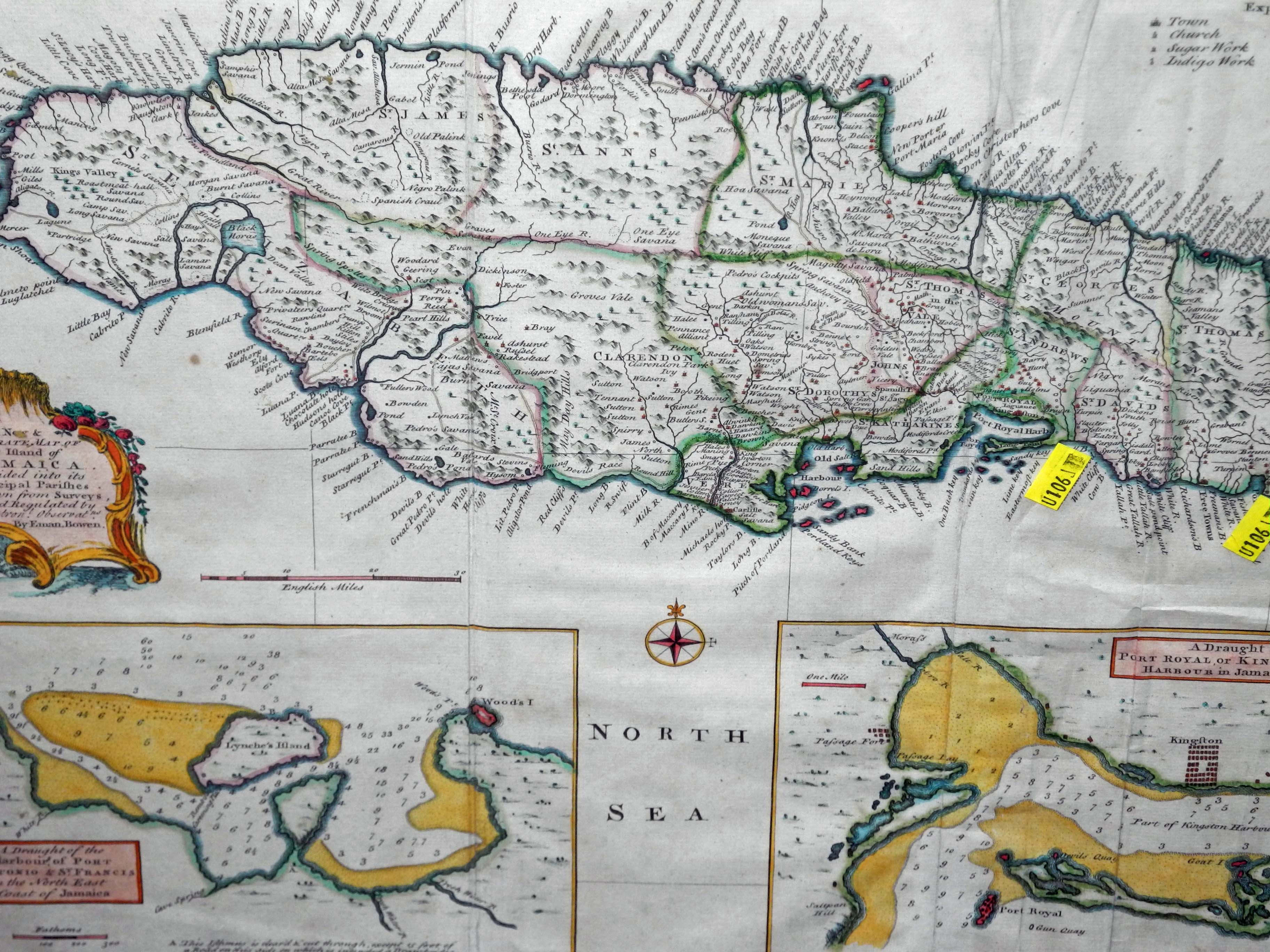 An early hand coloured map of the Island of Jamaica by Emanuel Bowen, mounted, glazed and Hogarth