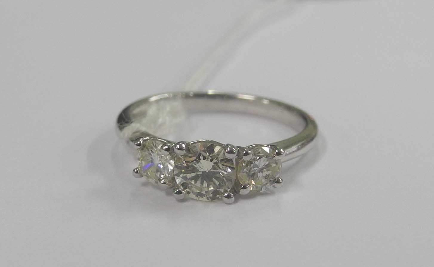 An 18ct white gold and diamond three stone ring (1.09pts.).