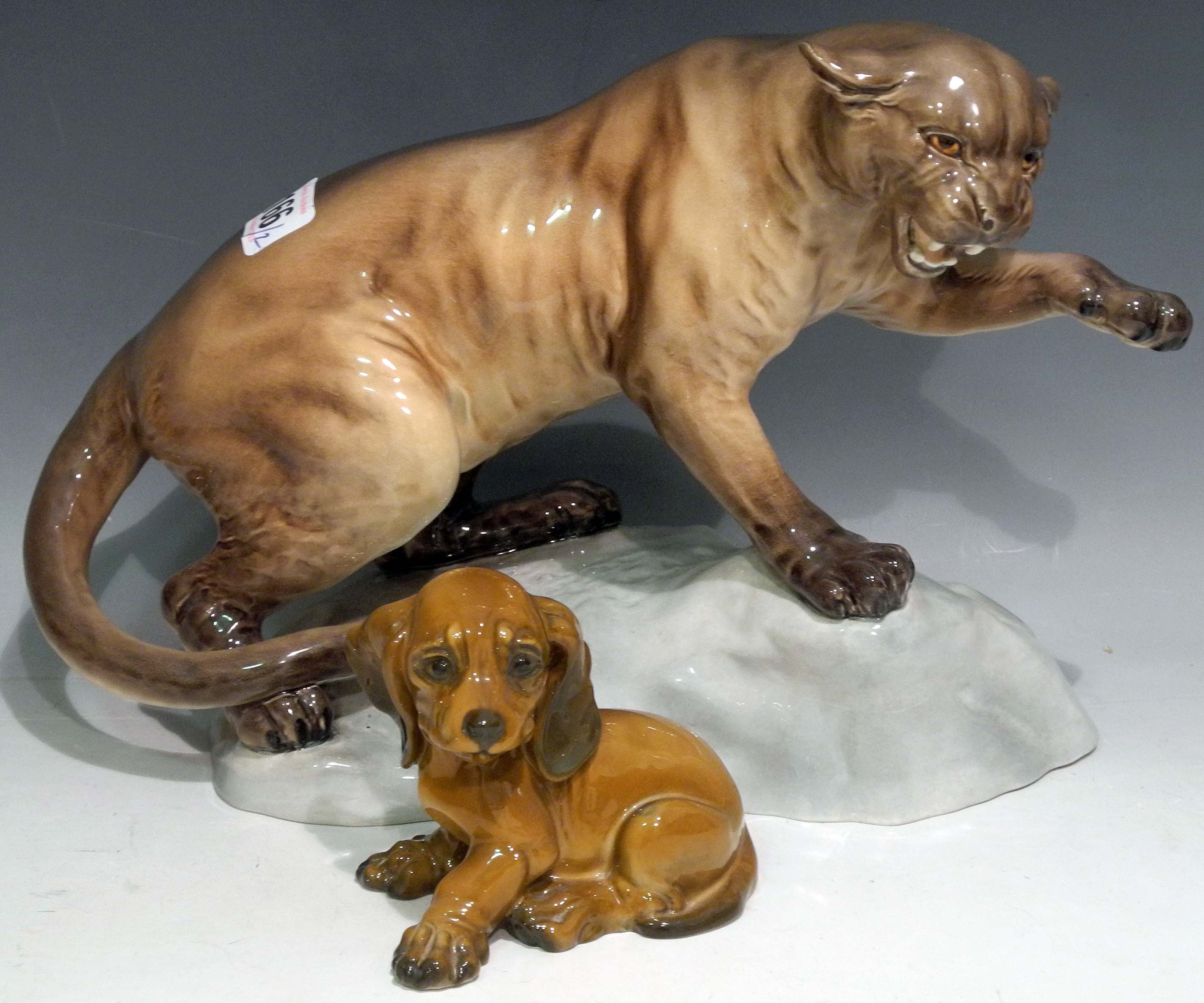 A Beswick ceramic model of a cougar and a Rosenthal porcelain Dachshund puppy. (2)