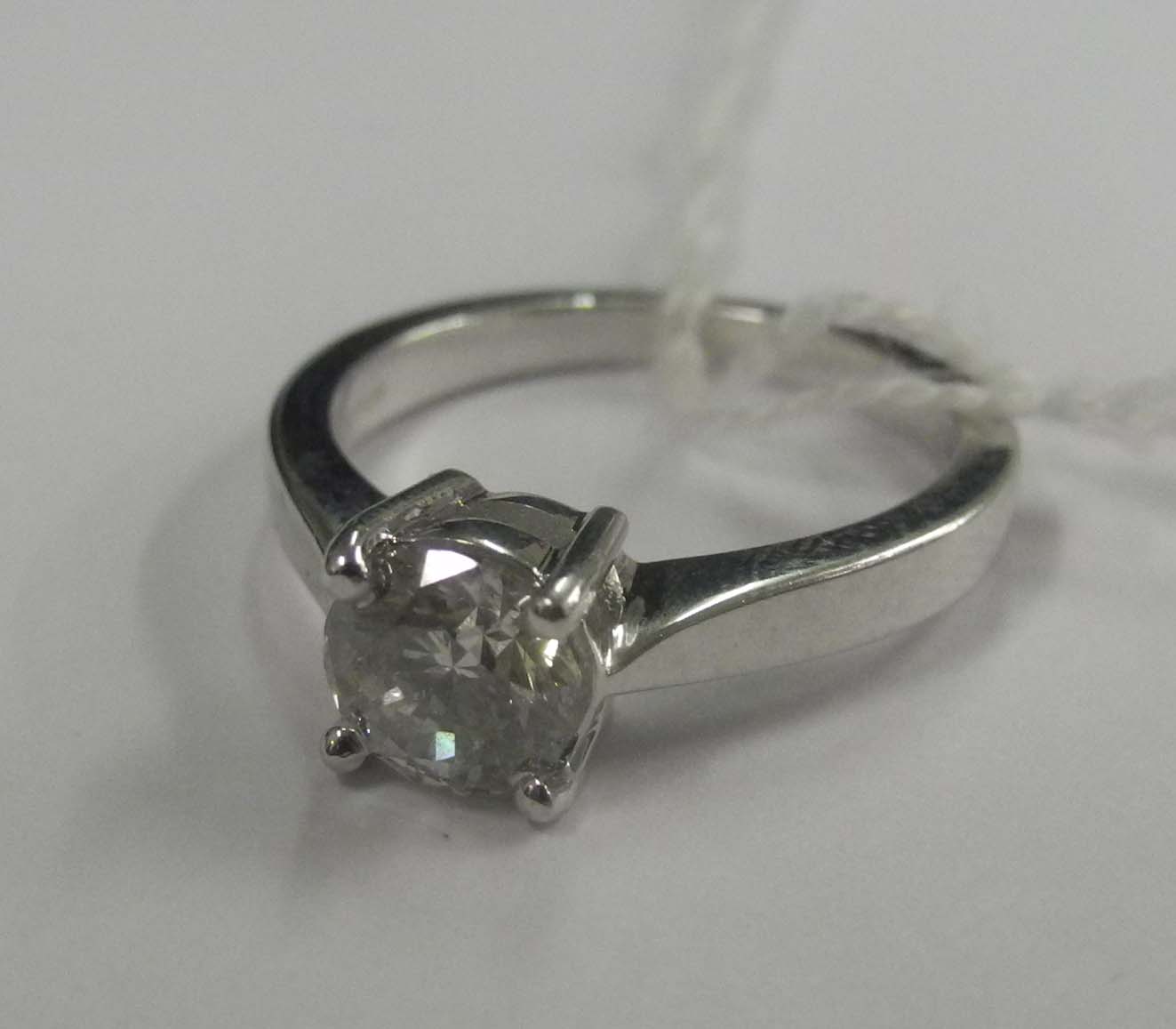 An 18ct white gold and diamond solitaire ring, the claw set brilliant round cut stone being 1.01pts.