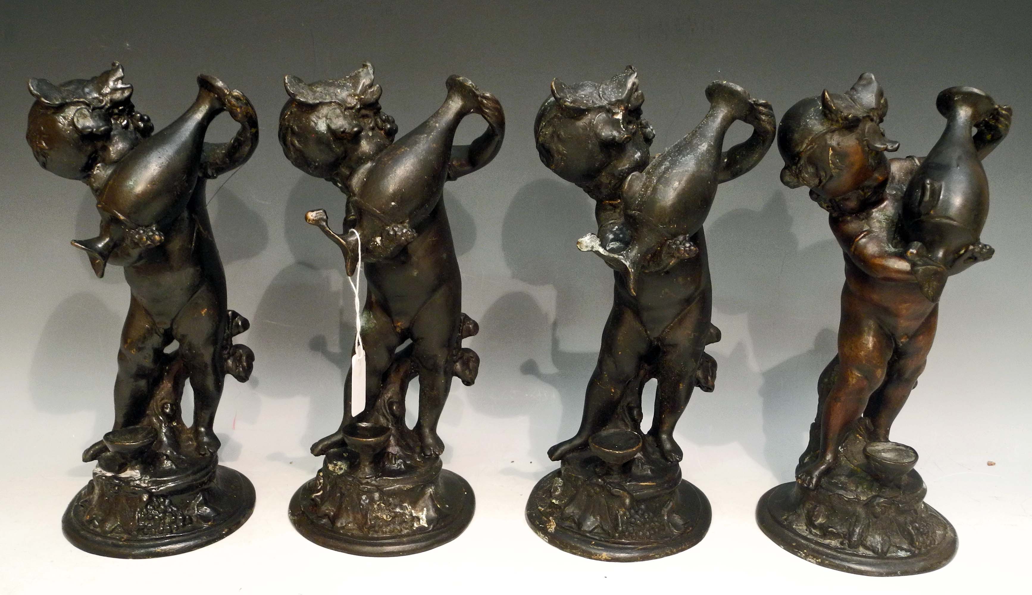 A set of four bronze putti carrying Greek urns. (4)Approx. 25.5cm