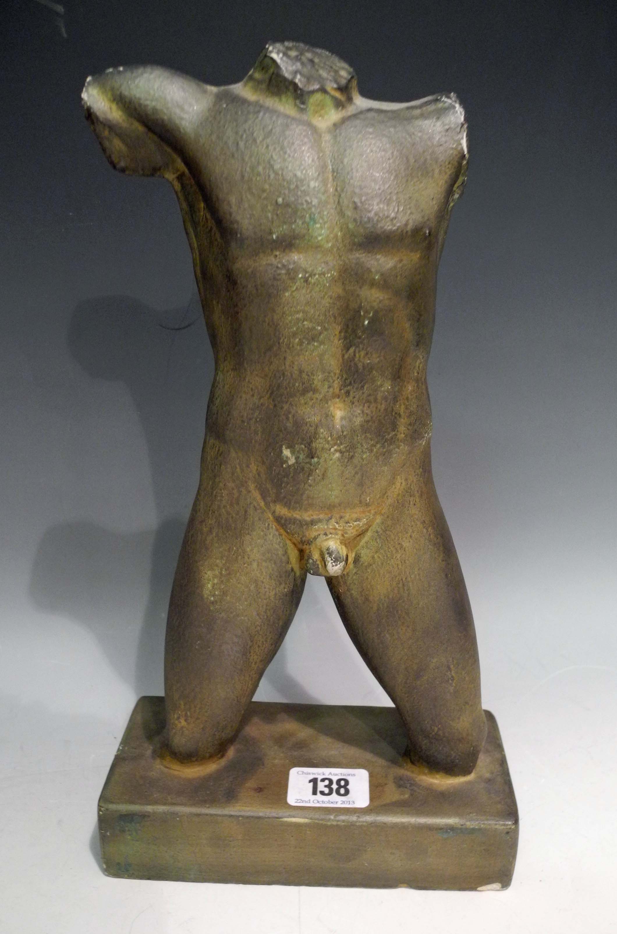 A classical form male torso in patinated plaster, supported from a rectangular base (height 31cm).