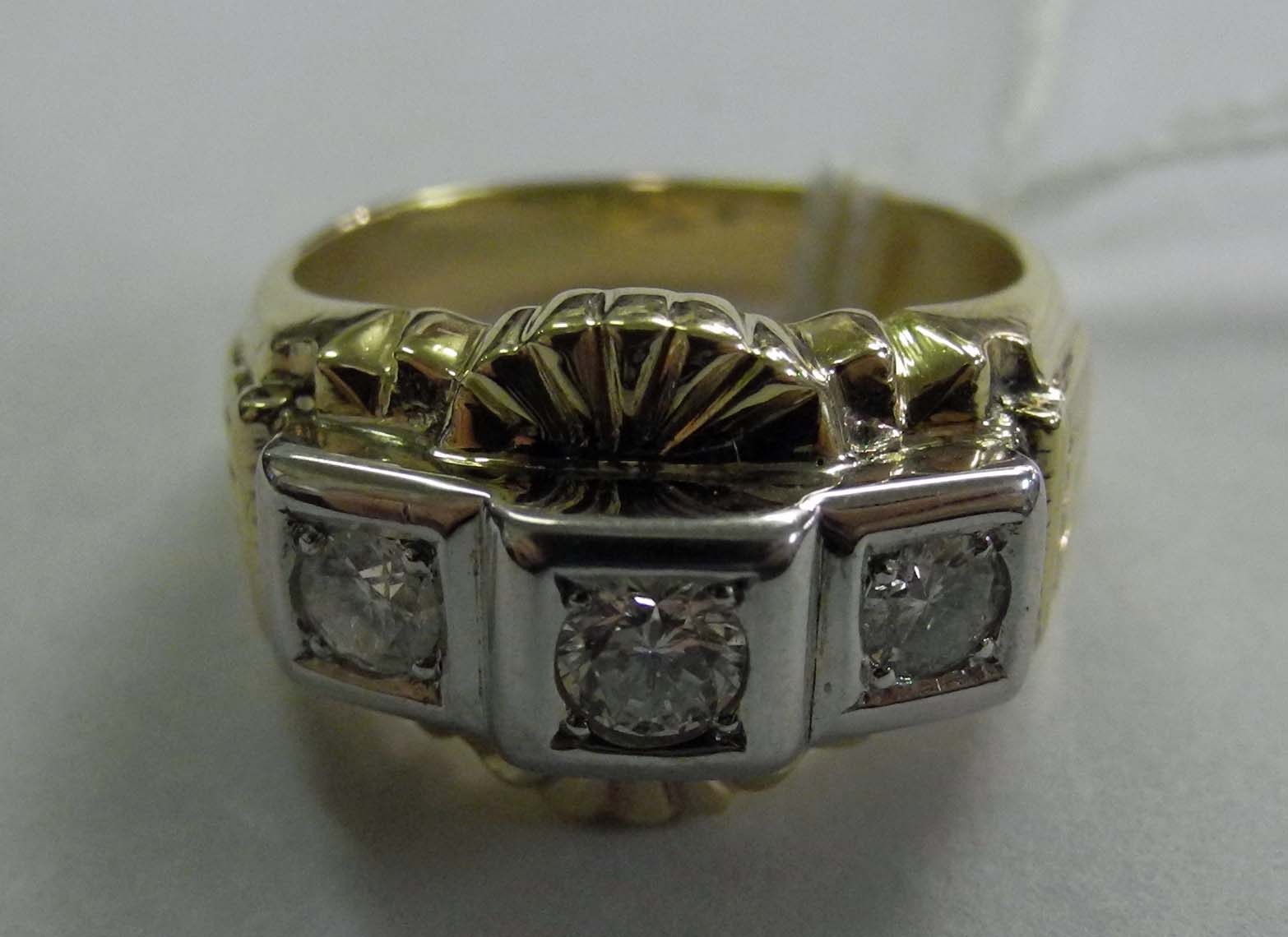 A yellow and white metal gentleman`s three stone diamond ring.