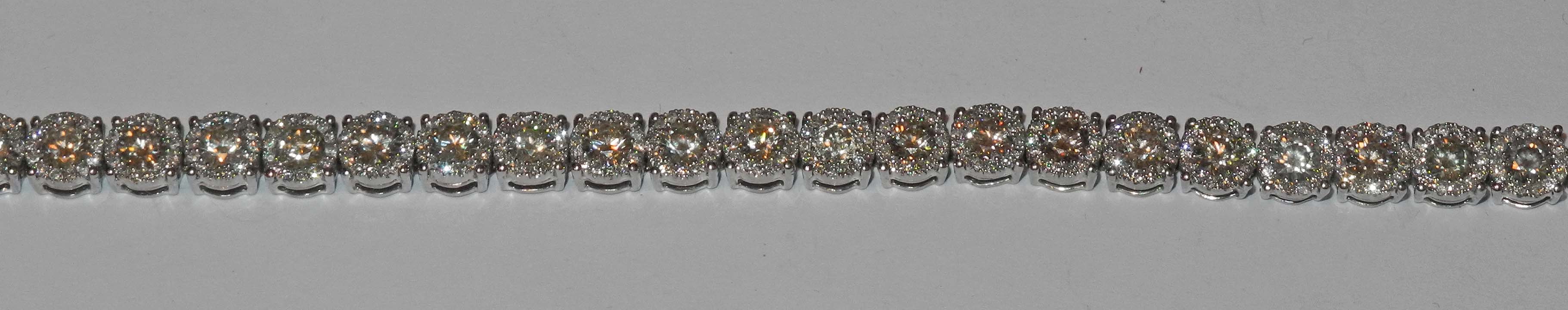 An impressive 18ct white gold and diamond multi-cluster line bracelet (9.5cts total).
