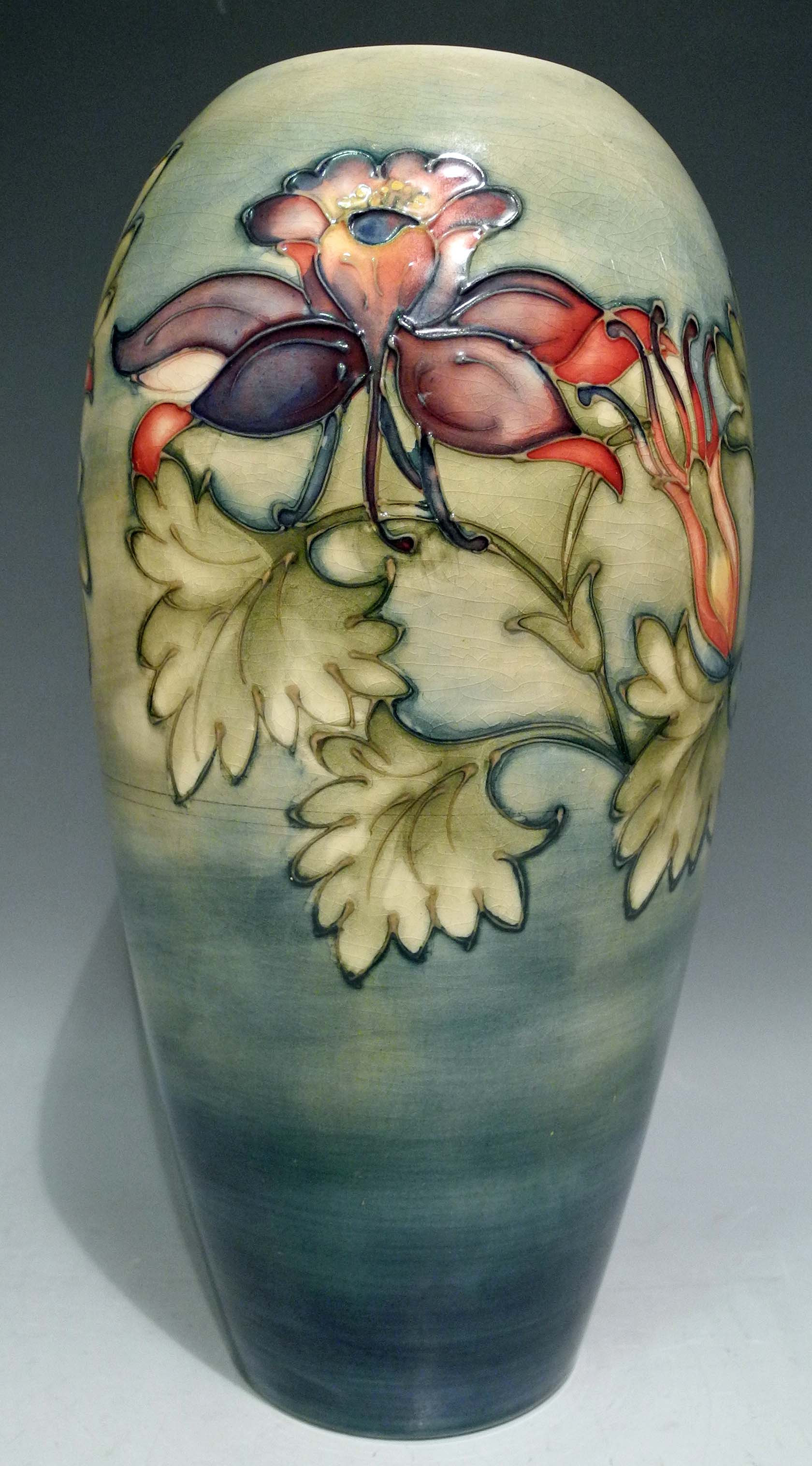 A Moorcroft Freesia pattern vase, on green ground, bears signature and impressed stamps, circa