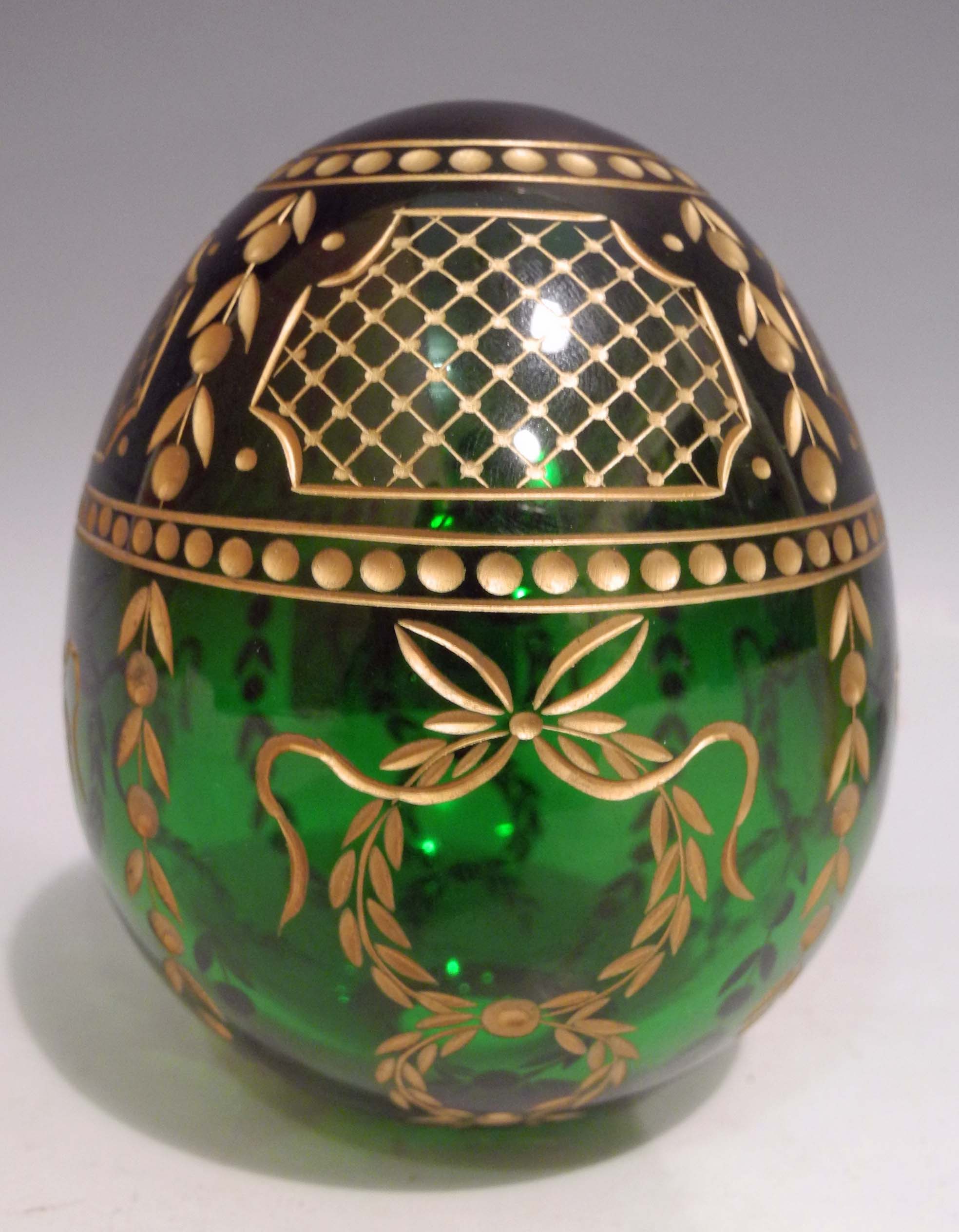 A modern Russian green glass Easter egg, having gilded decoration, made in St Petersburg in the