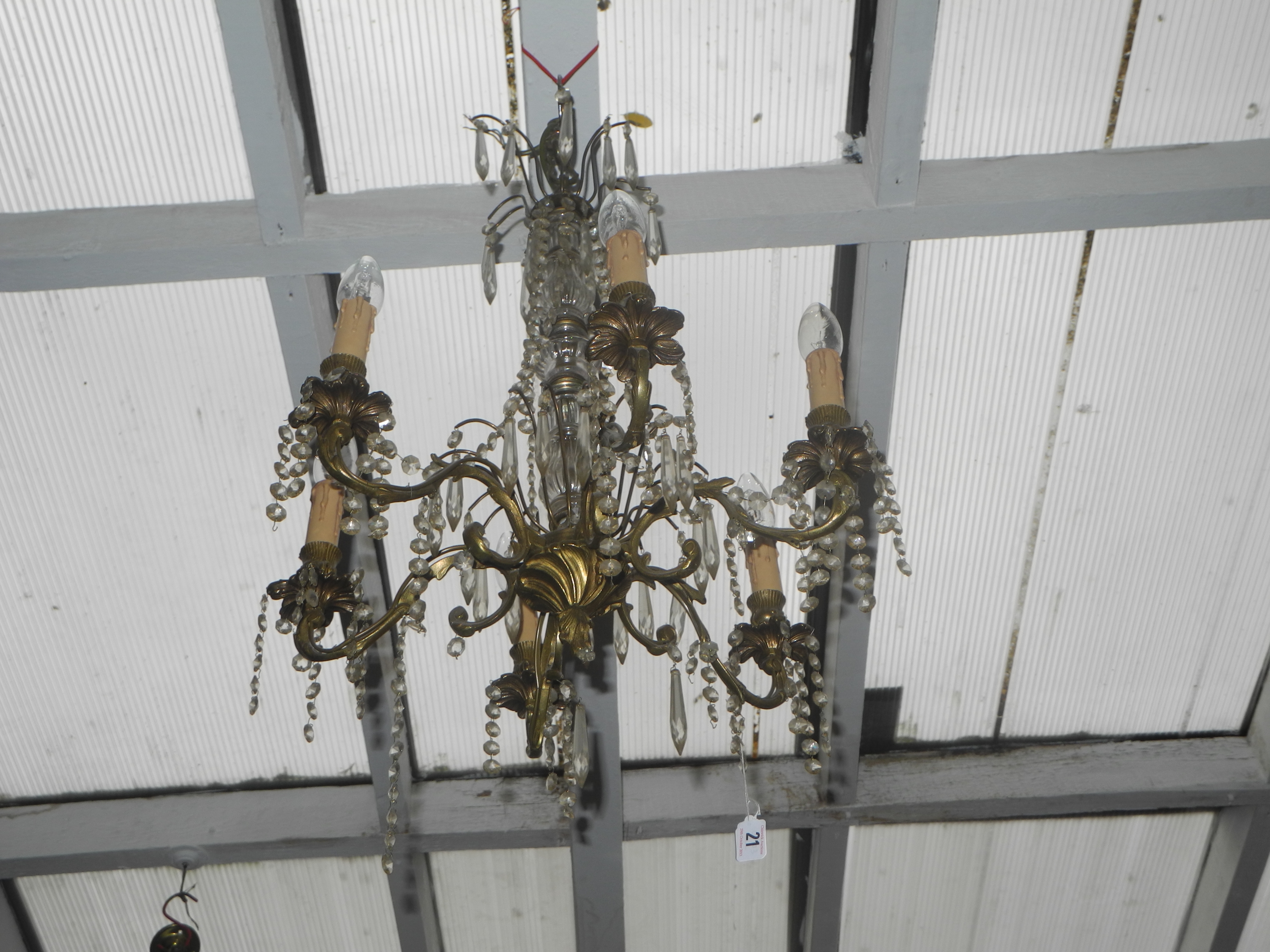 An early 20th Century electrolier, with six acanthus scroll decorated arms having petal `drips`,