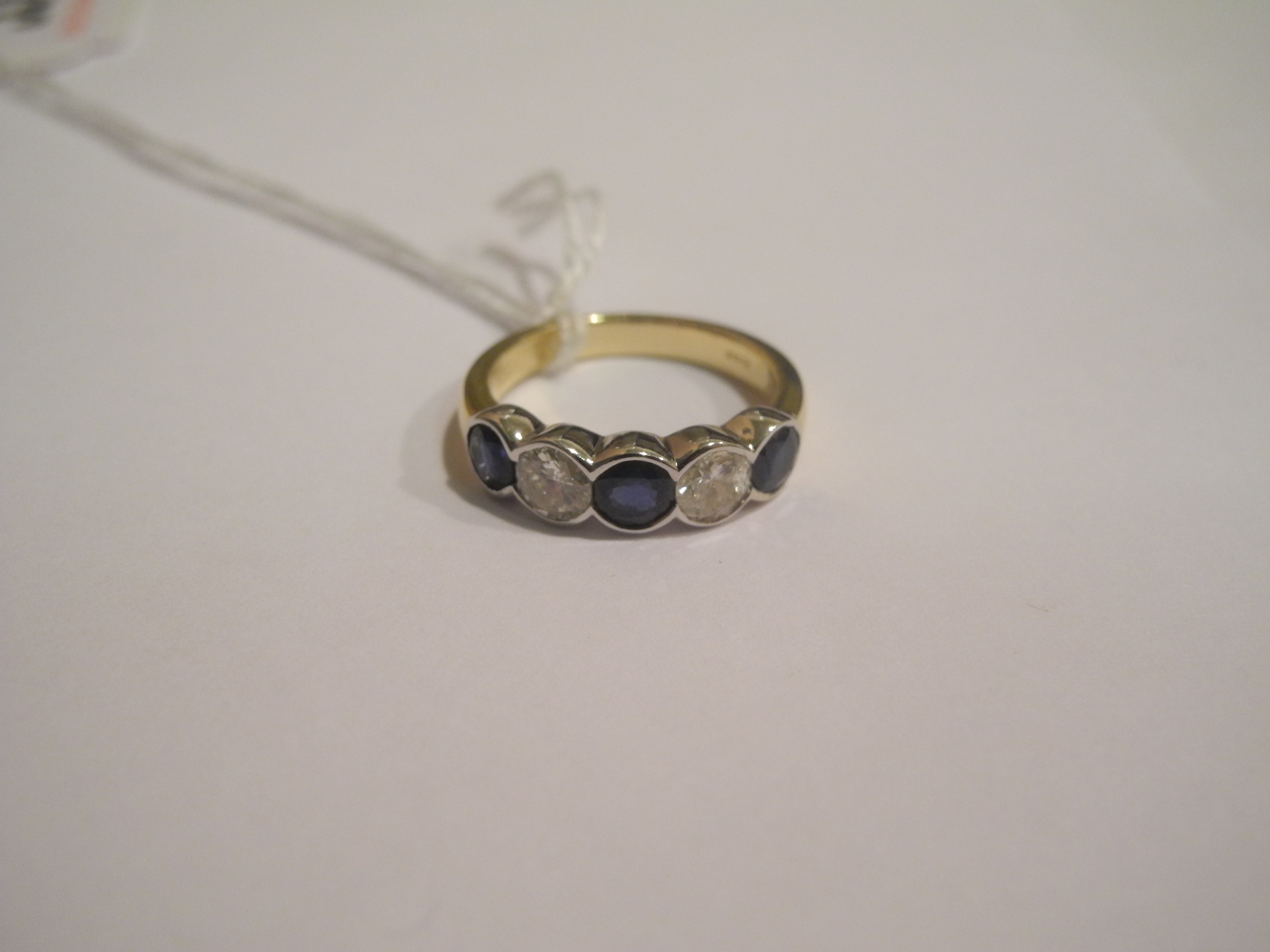 An 18ct gold, diamond and sapphire five stone ring (sapphire 1.31cts, diamond 0.75cts).