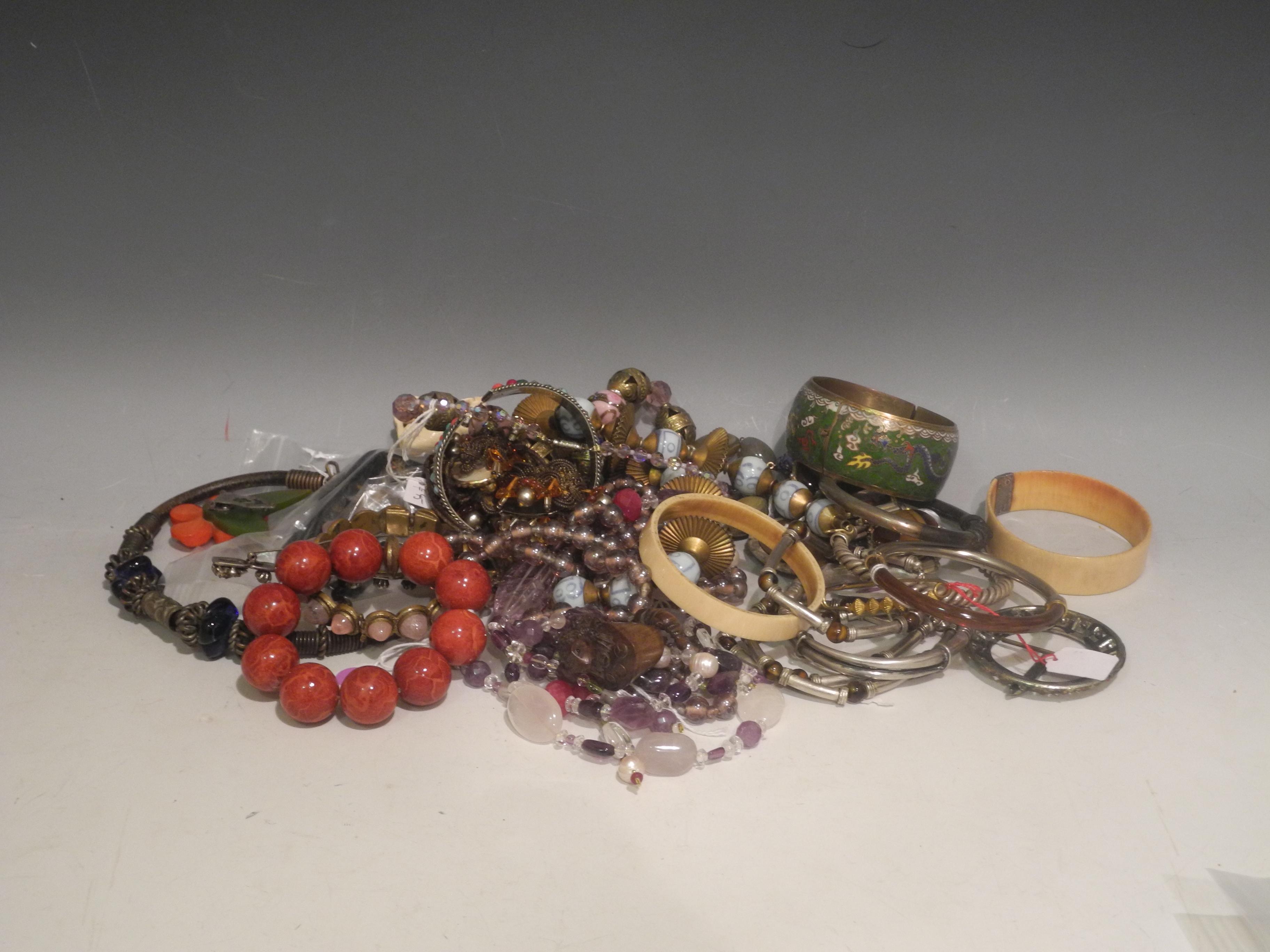 A bag of costume jewellery to include necklaces, stone beads, bangles, fancy glass beads, etc. (Qty)