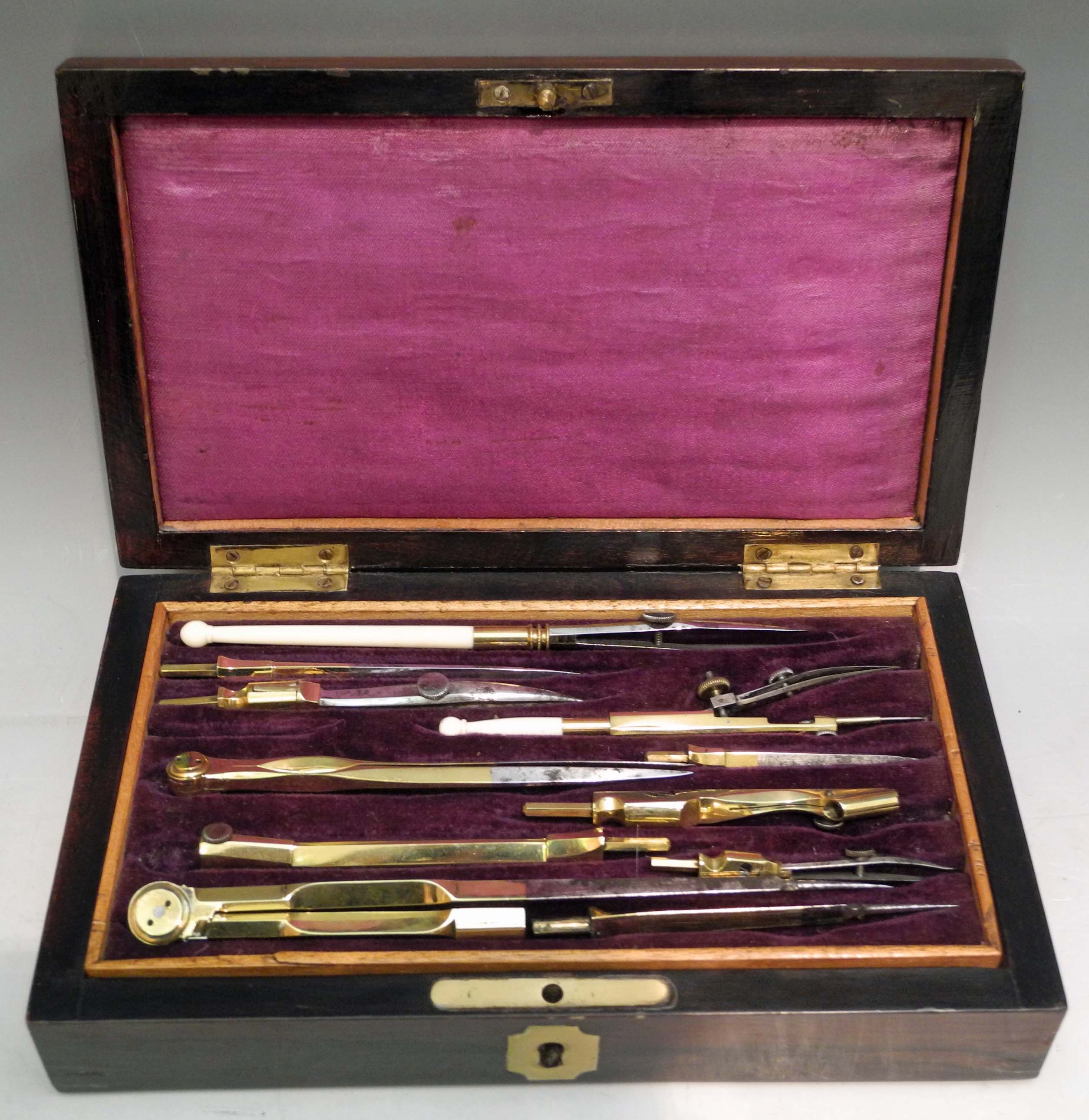 A mid Victorian rosewood boxed set of drawing implements, many with gilt handles, sold complete with