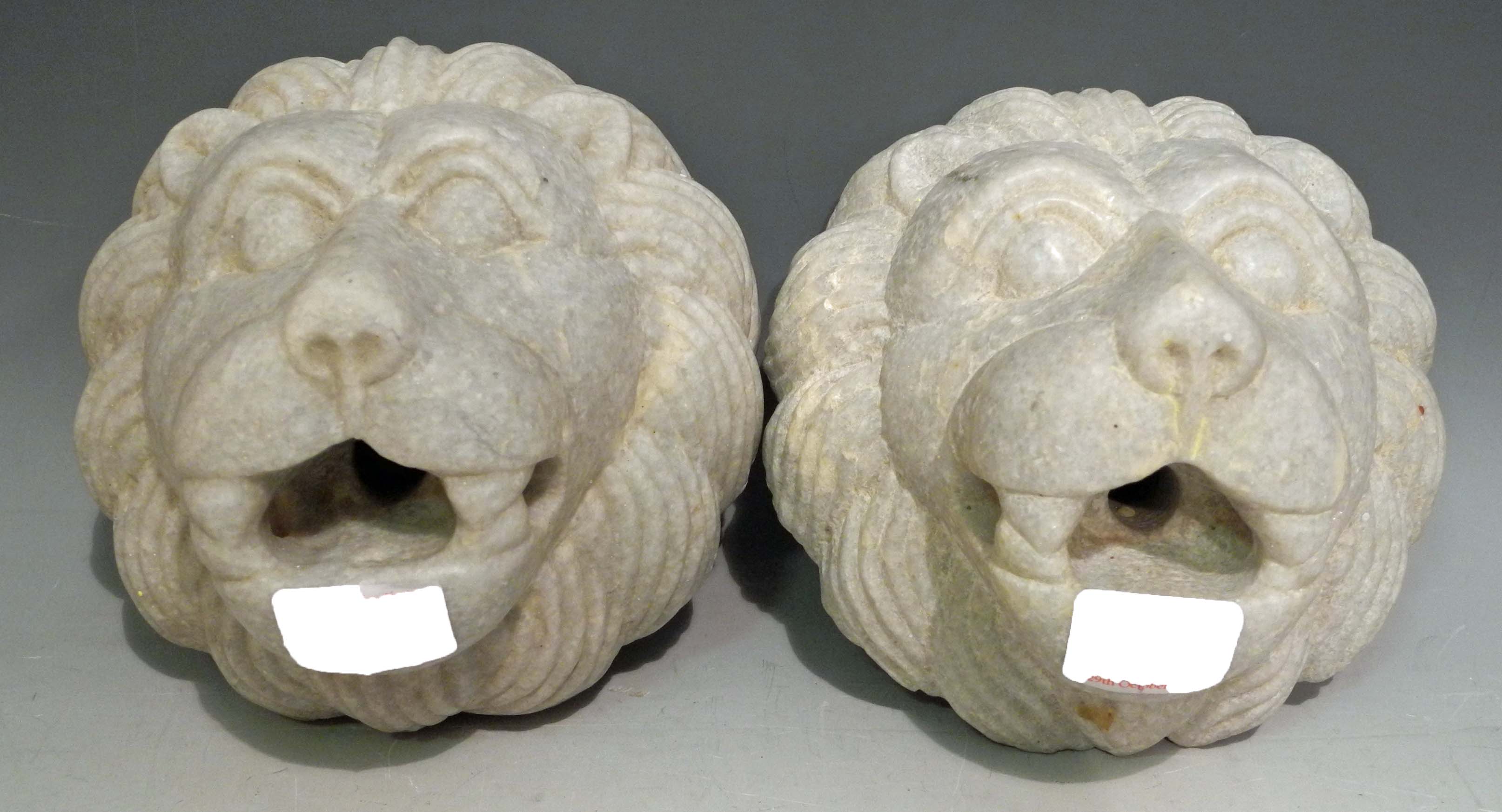 A pair of mid 20th Century carved marble fountain spouts in the form of lions` heads. (2)