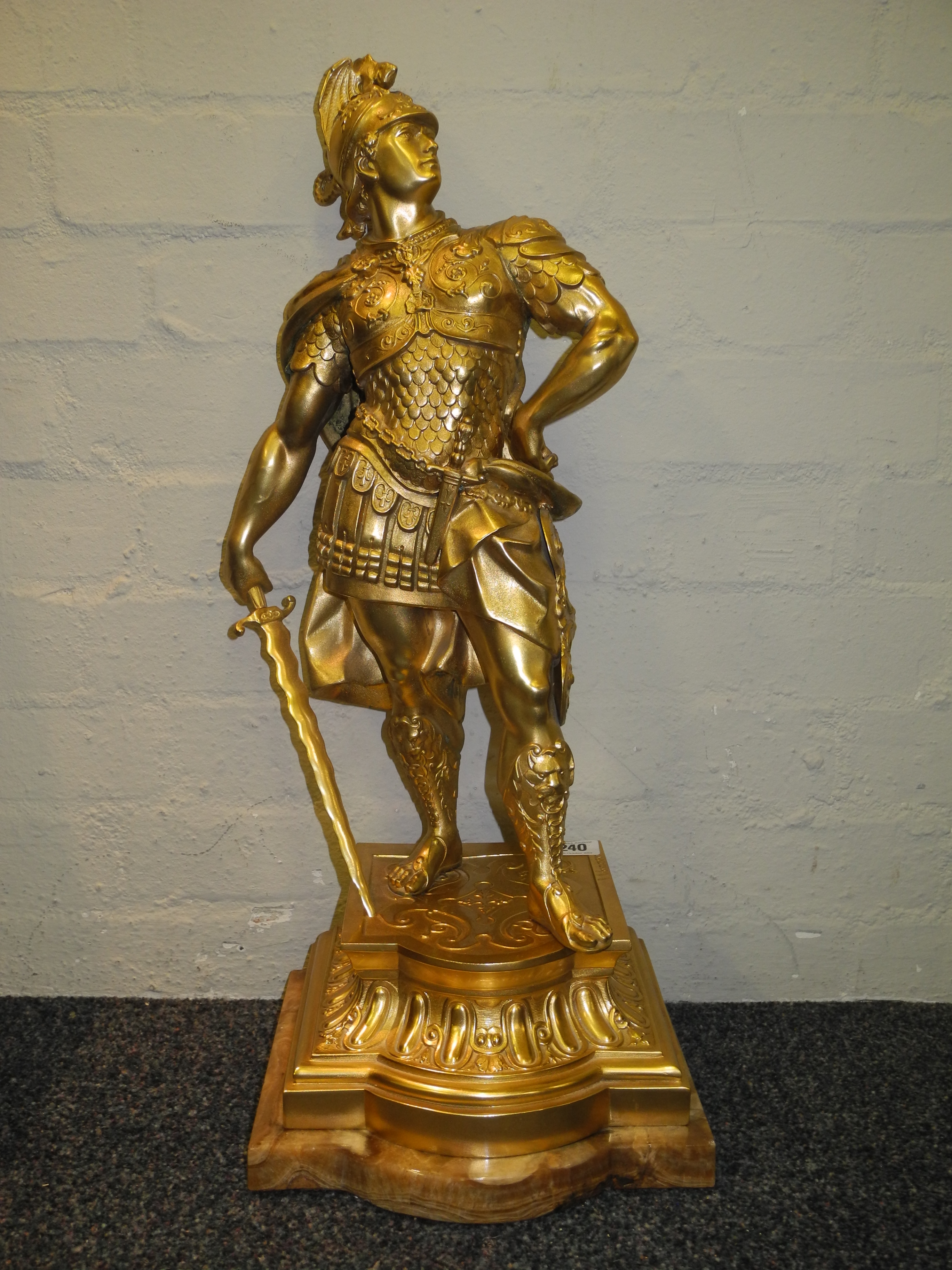 A large gilded spelter figure after the antique of Alexander striking a majestic pose.
