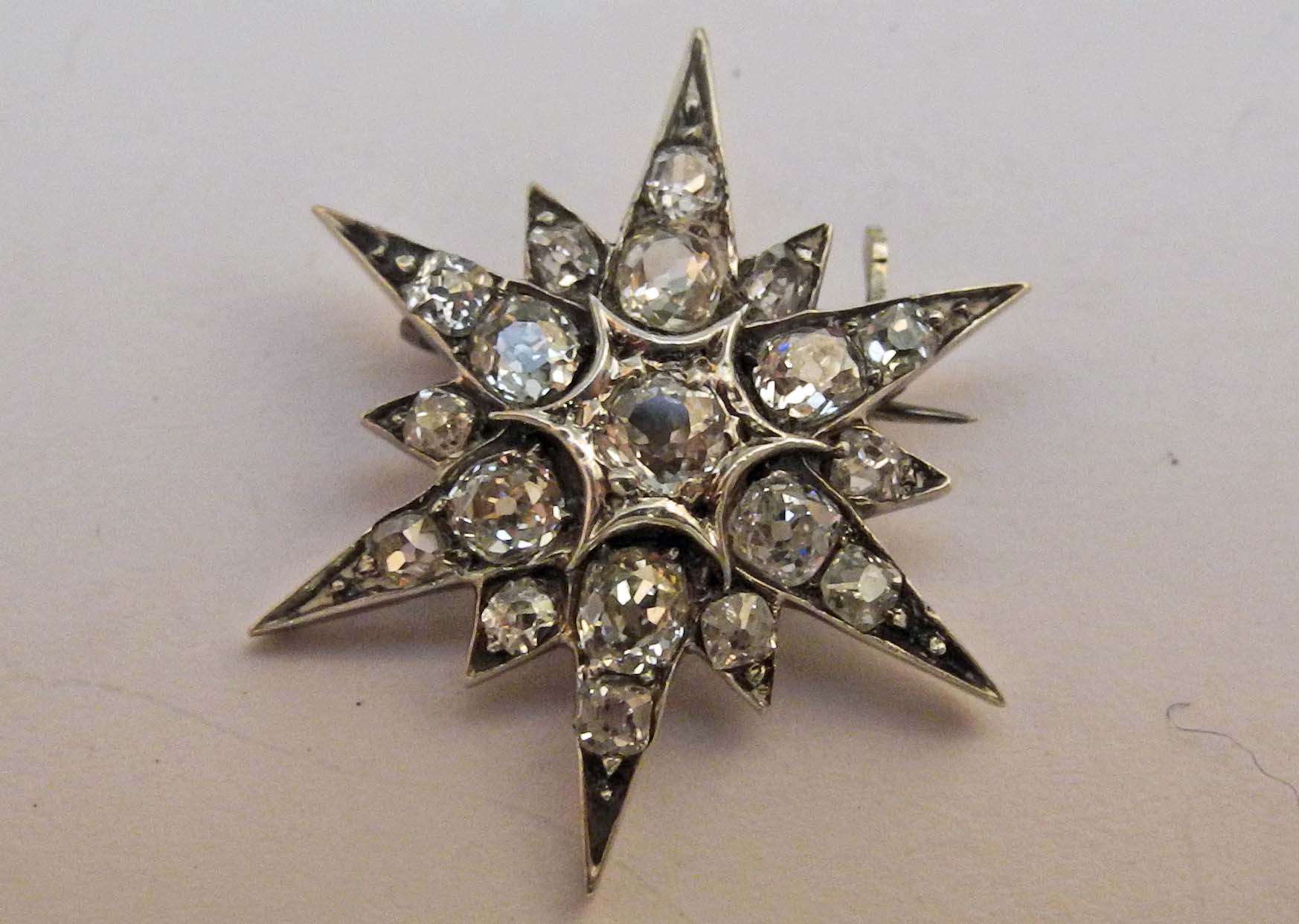 A 19th Century white metal (possibly gold and silver) star shaped pin brooch with diamonds.