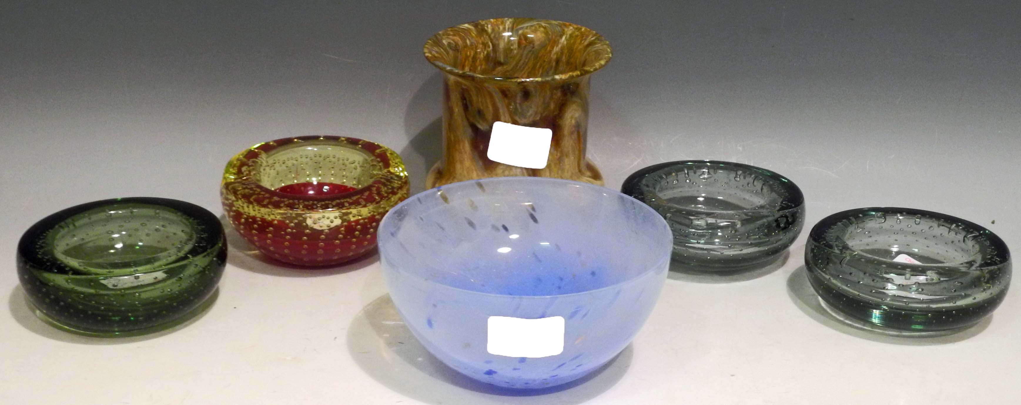 A Caithness glass bowl, four Whitefriars glass ashtrays with bubble inclusions and a "Monart" or "