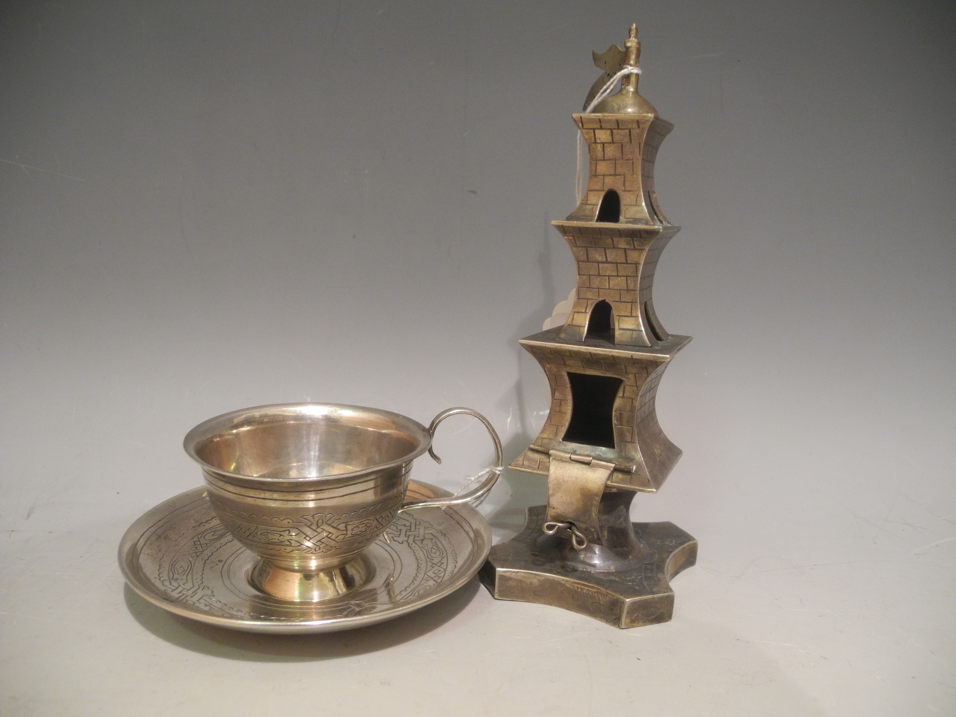 A Russian .84 silver spice tower sold together with a Russian .84 silver cup and saucer. (3)