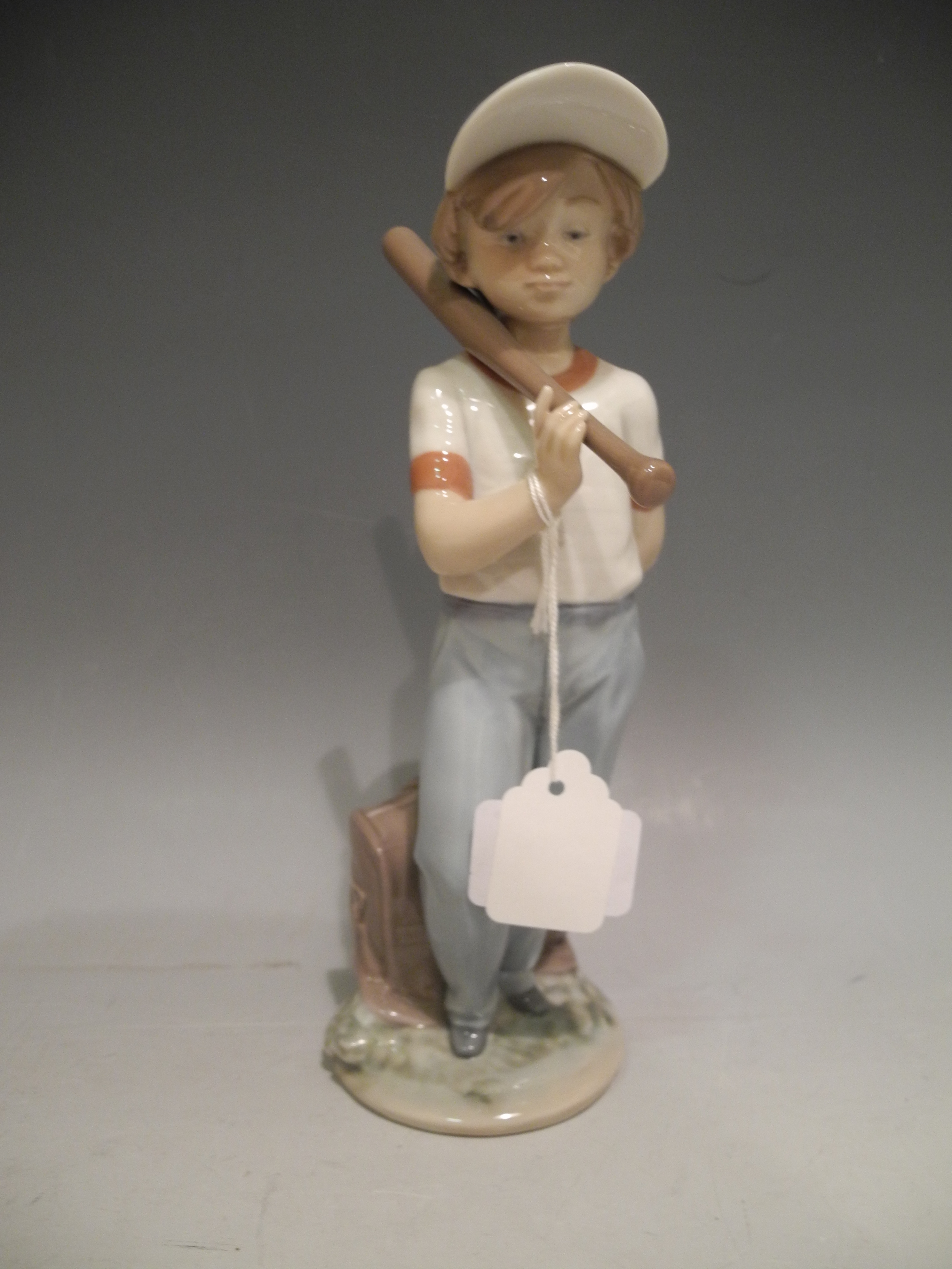 A Lladro porcelain model of a boy, titled `Can I Play?`, issued 1990, last year 1991, ref no 7610,