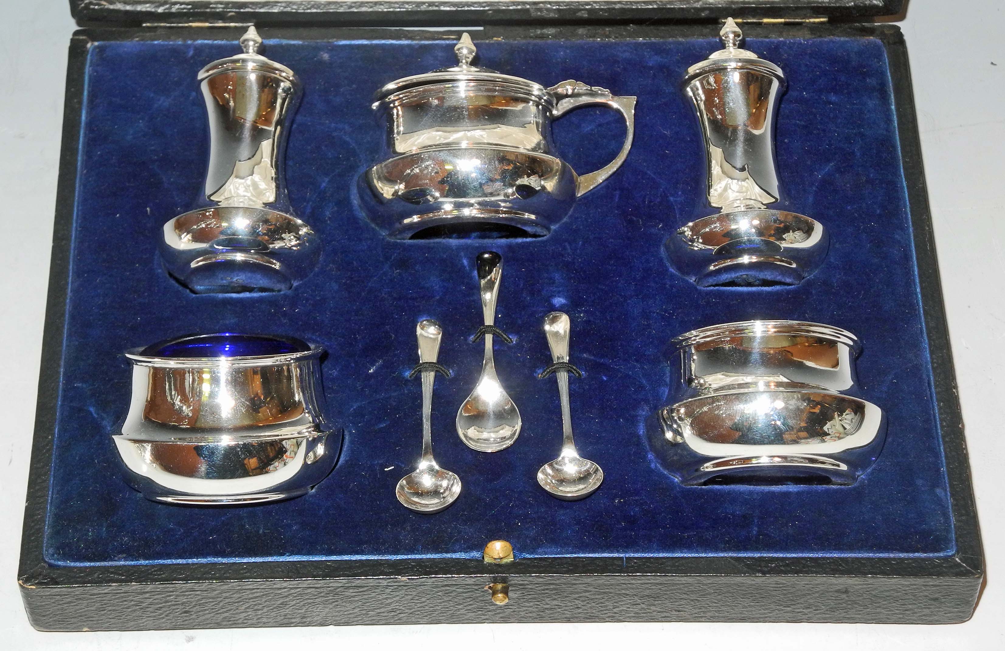 A cased hallmarked silver condiment set (Birmingham circa 1920, Deakin & Francis), sold together