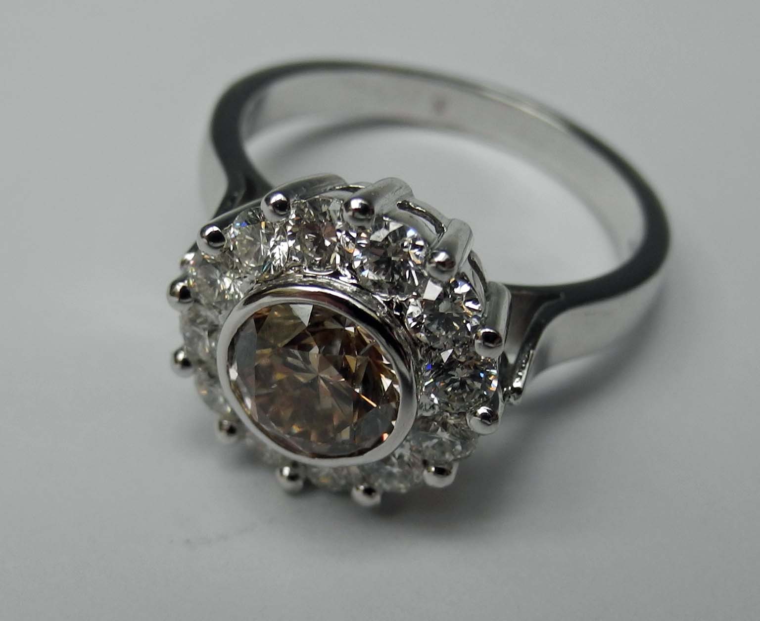 An 18ct white gold and champagne diamond cluster ring (diamond weight to centre stone 1.52).