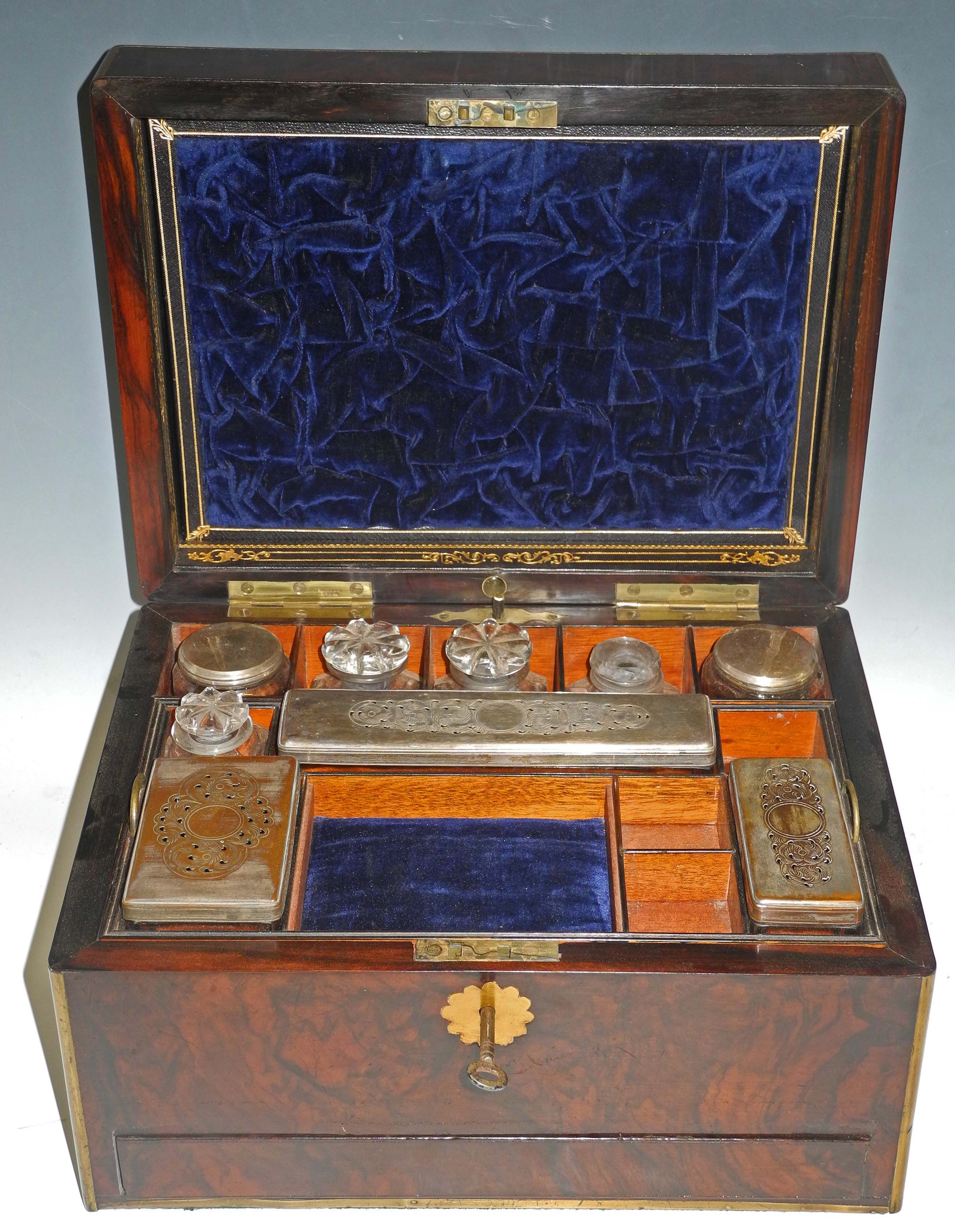 A Victorian figured walnut and brass banded vanity case, the rising hinged lid opening to reveal a
