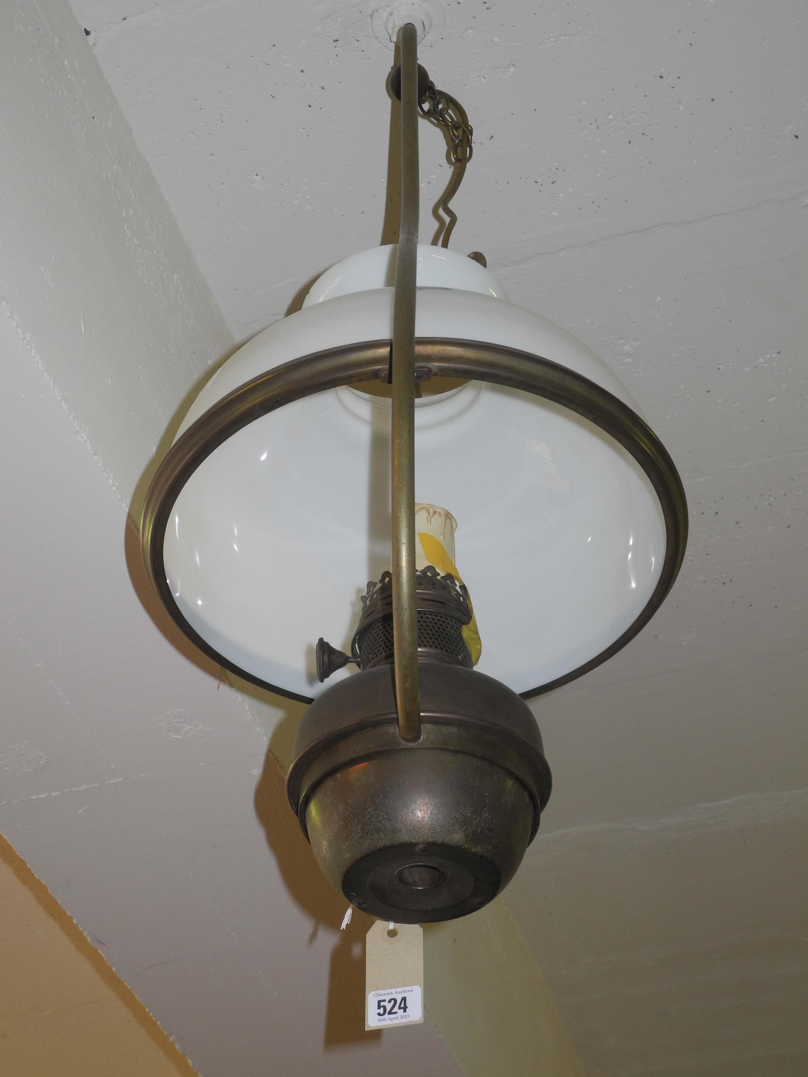 An Edwardian ceiling suspended brass oil lamp with white glass shade.
