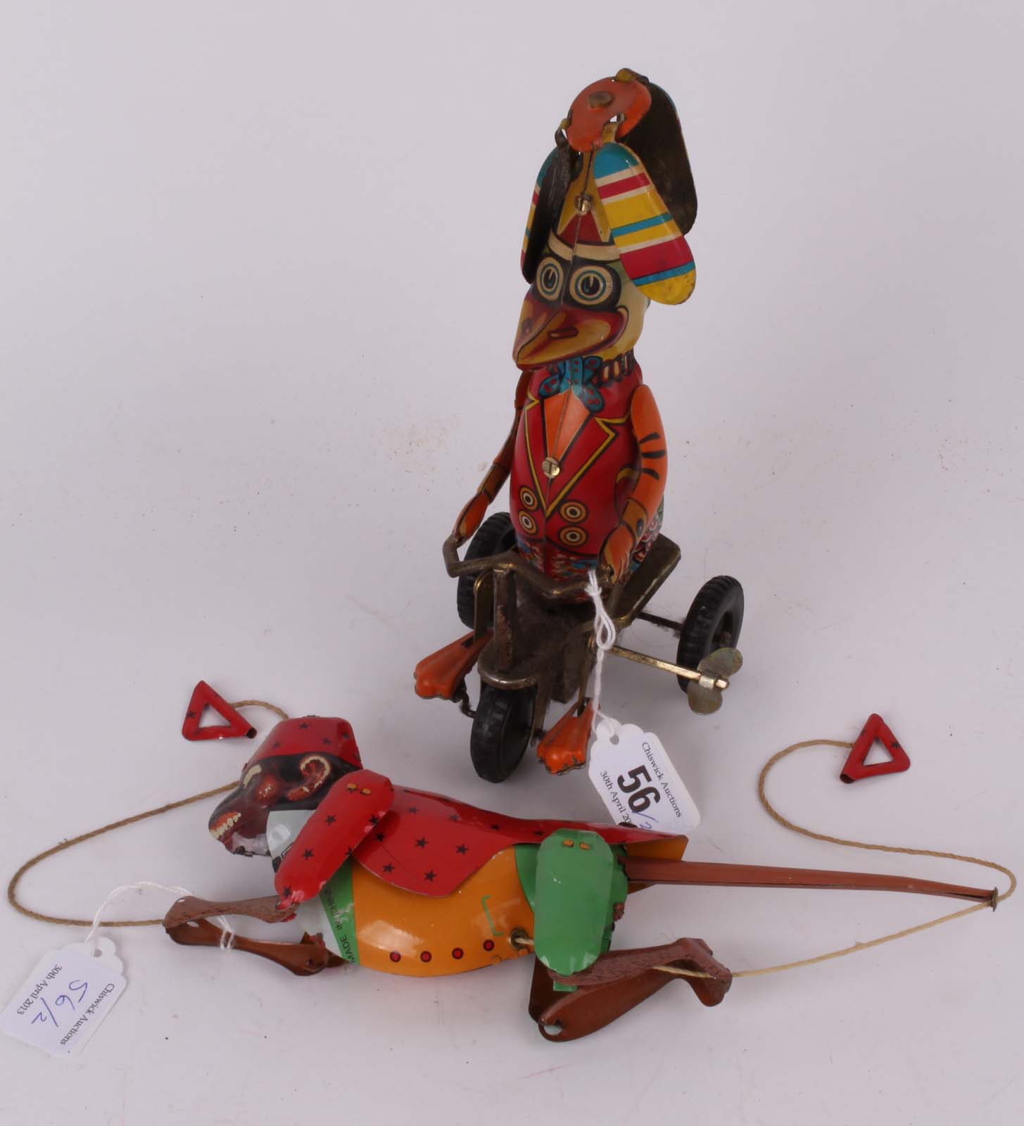 Two vintage coloured tin toys, a climbing dress monkey with pull string climbing string marked TX,