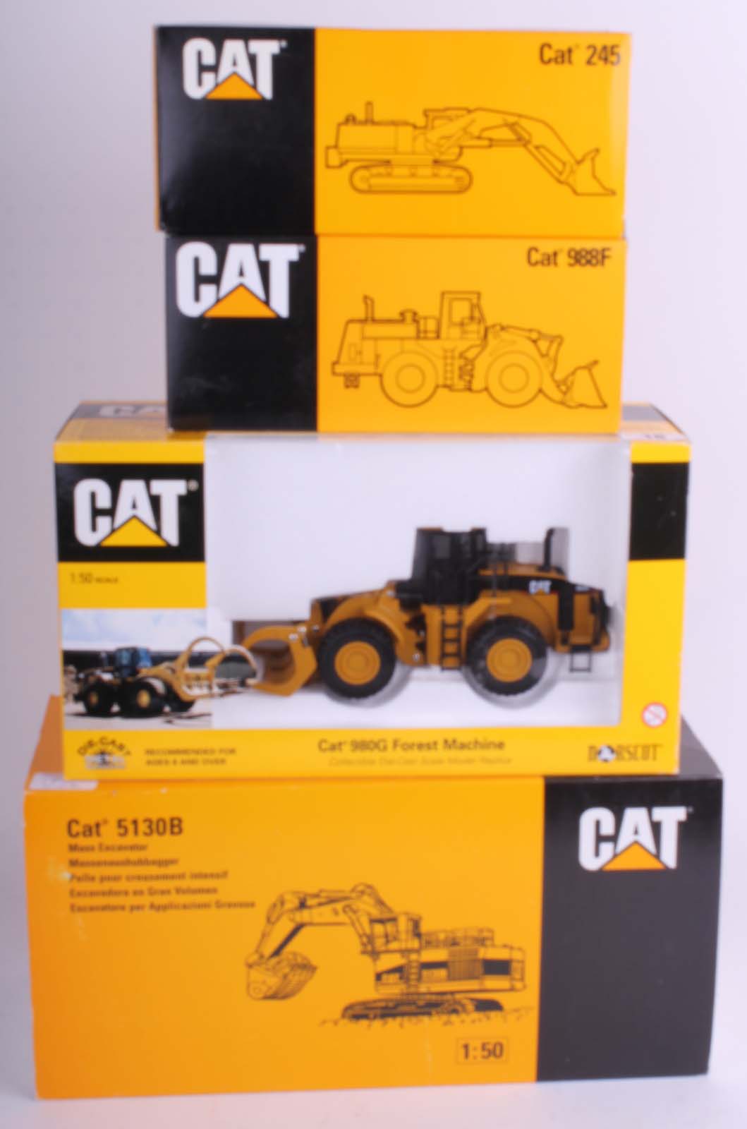 Four contemporary large scale CAT (mint in box) plant machinery, including: 980G Forest Machine,