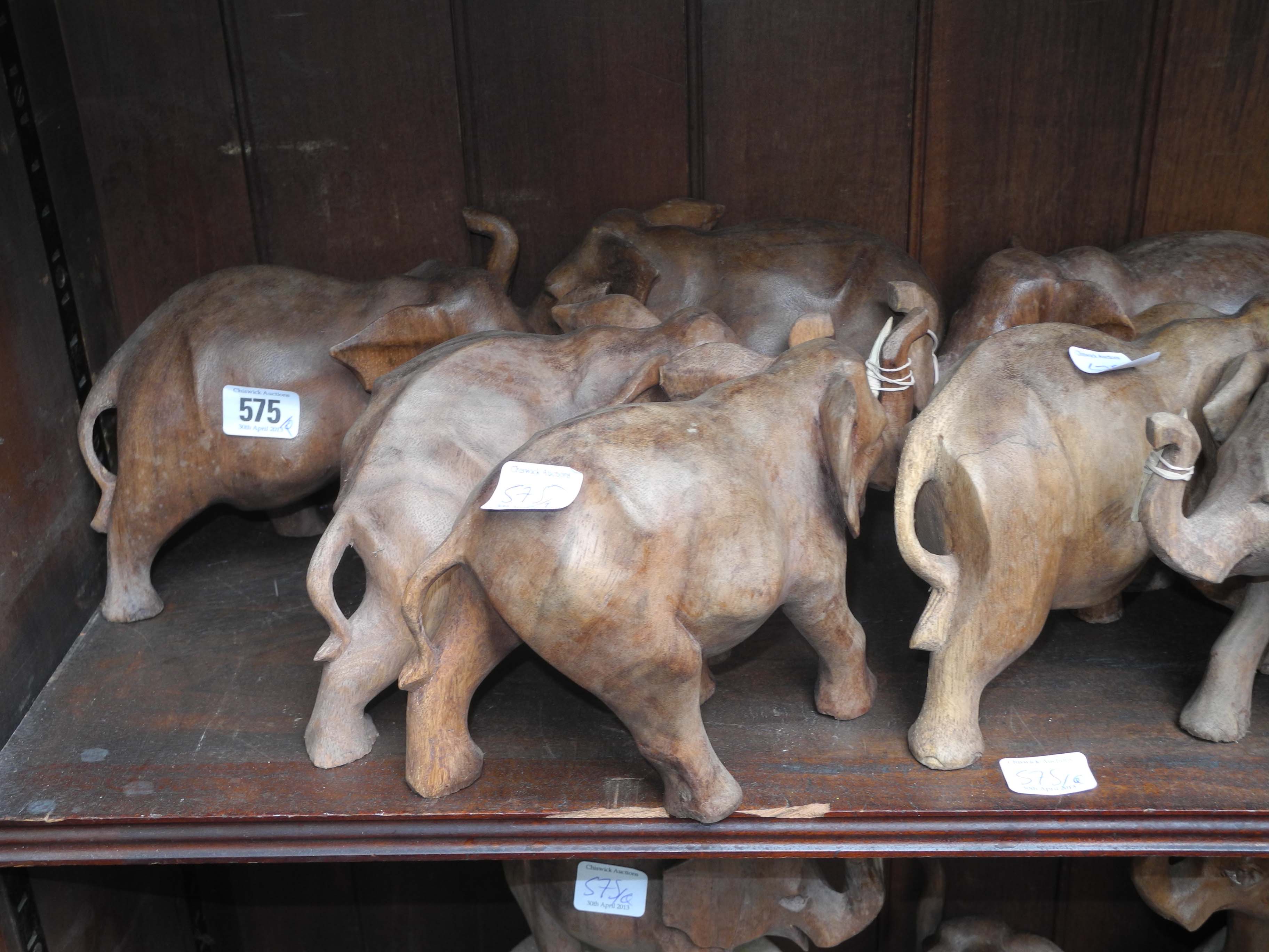 A quantity of African carved wood elephants.
