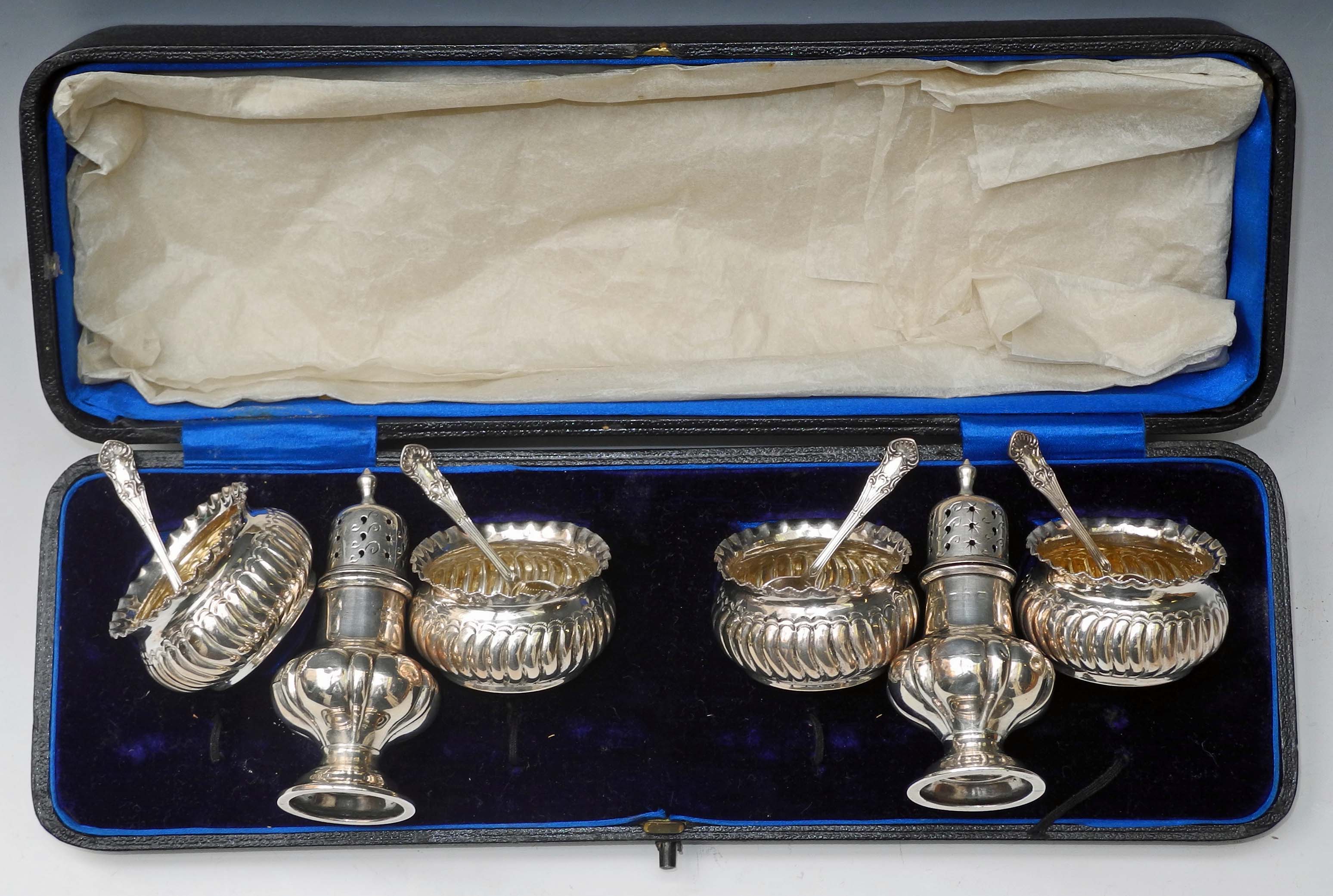 A cased set of four hallmarked silver salts and spoons, sold together with a pair of hallmarked