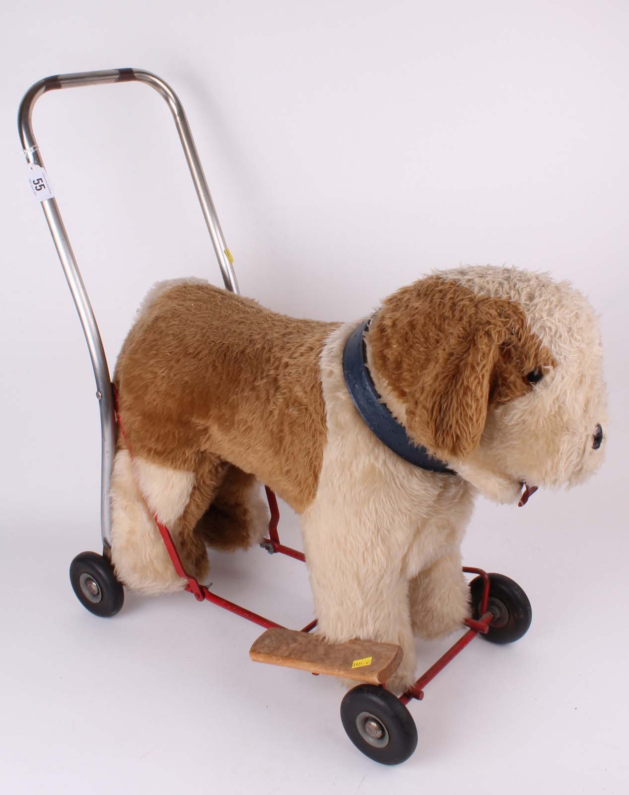 A Tri Ang Saint Bernards sit on or push along child`s plush toy on metal frame with four rubber