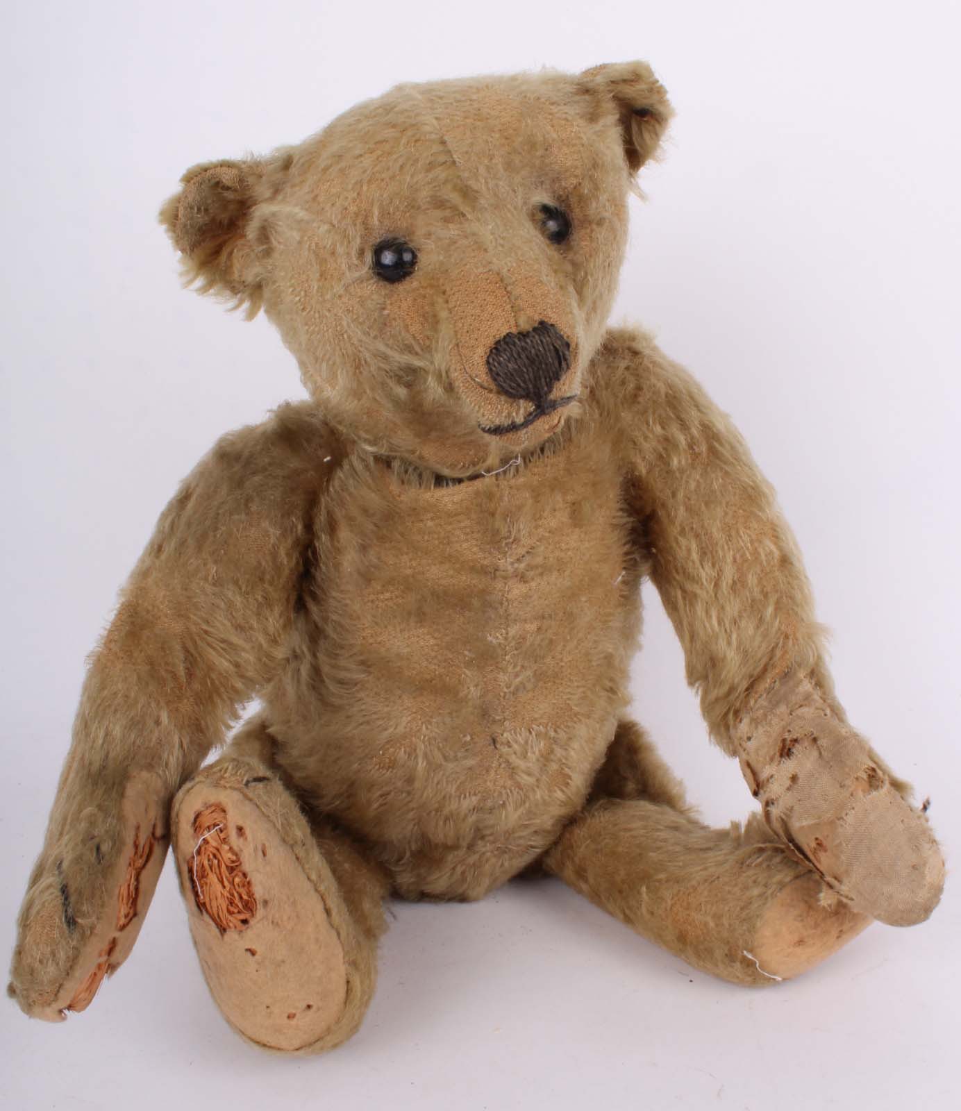 A Steiff centre seam 1909 golden mohair Teddy bear, with button, fully jointed, having black