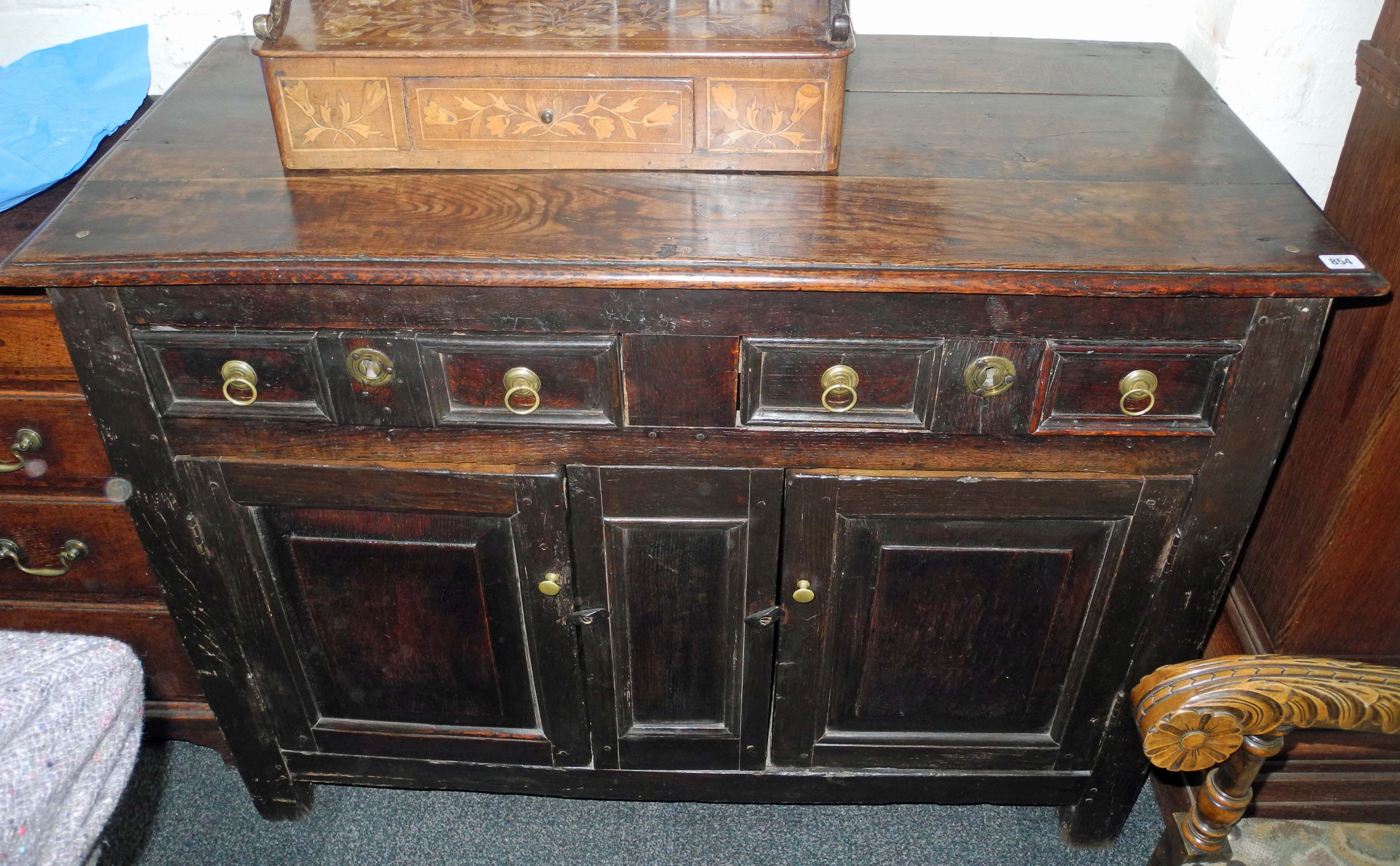 An antique provincial oak and chestnut dresser base in 17th century style, the two short drawers