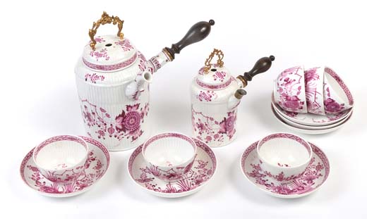 A fine 18th century Meissen chocolate pot and cover, with puce floral decoration, ormolu swing