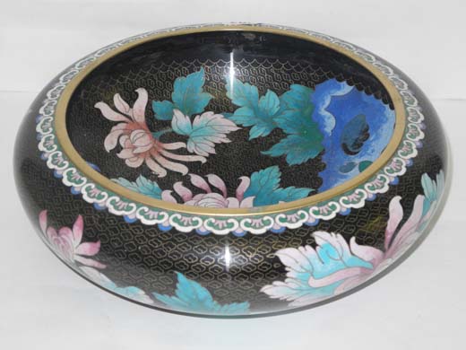 A large 20th century cloisonne bowl decorated with polychrome enamels on a noir ground.