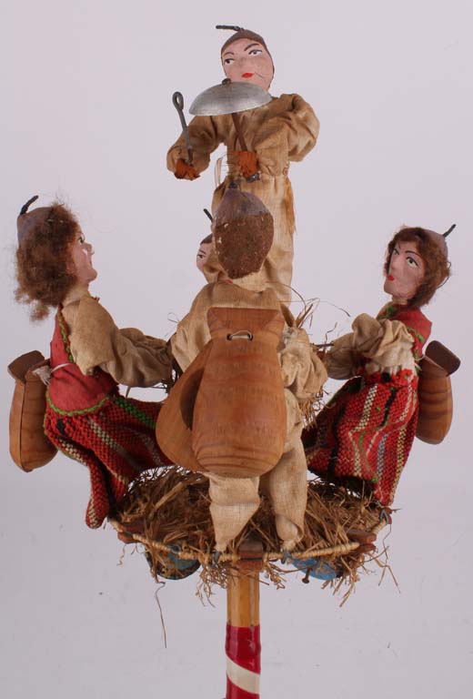 A dancing Hungarian band of five dolls, on a hand held toy, with a pull mechanism to make them