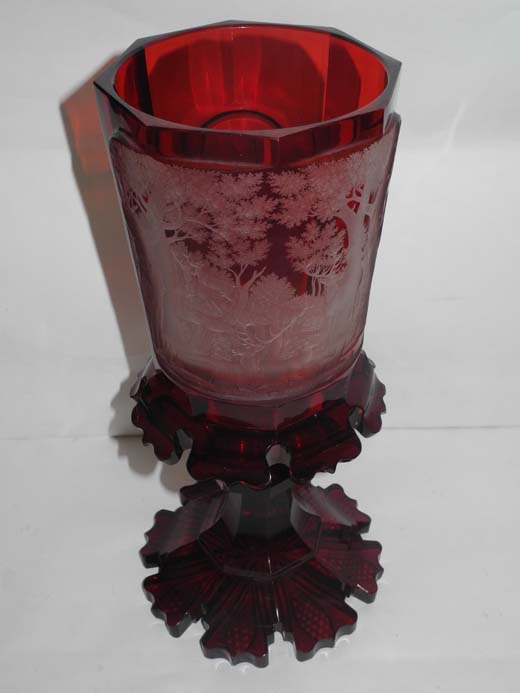 A late 19th century Bohemian ruby glass goblet vase, the upper section finely wheel engraved with