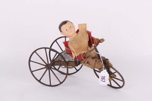 A very rare Stevens & Brown tricycle, depicting a young boy out for a ride on his velocipede,