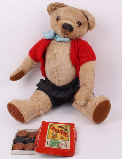 A character blonde mohair Teddy bear, dressed, English 1950s (lacks fur, played with, pads repaired)