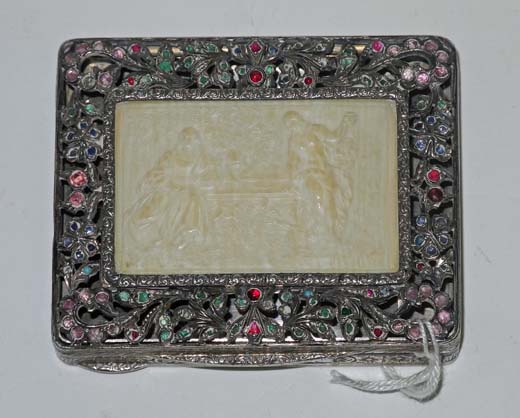 A late 19th/early 20th century continental white metal compact with pierced and gem set border,