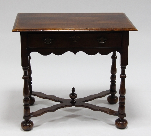 An oak table of 18th Century design, fitted a drawer, on baluster turned legs united by an X-