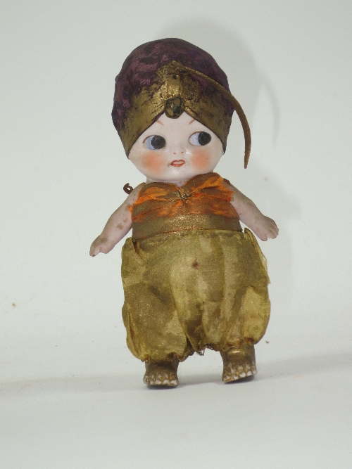 A bisque Googly doll, the eyes looking to the left, with swivel arms, wearing Arabian costume,