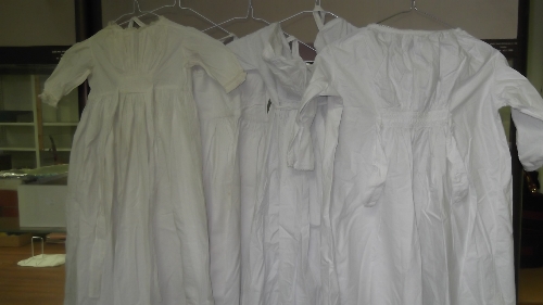 Five dolls'/children's white cotton dresses, various