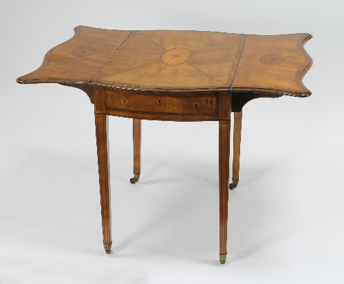 A George III satinwood serpentine leafed Pembroke table, the segmented veneer with central fan