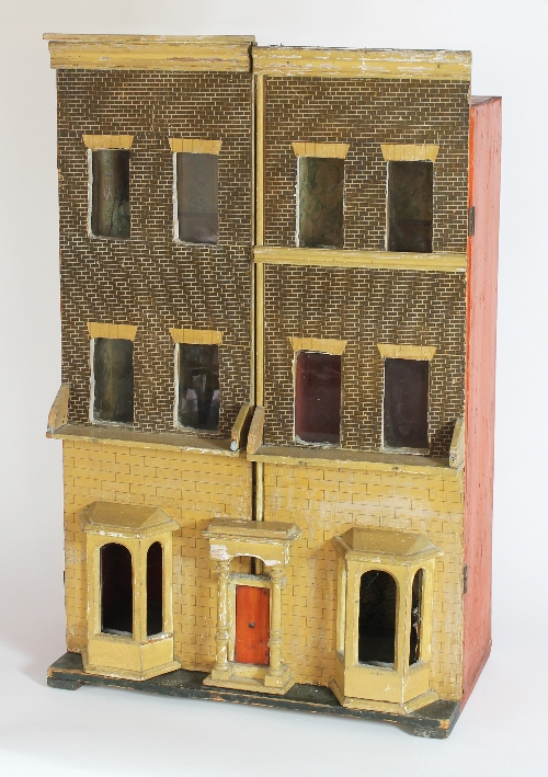 A late 19th Century dolls' house, the ground floor with front door and windows to the sides, the